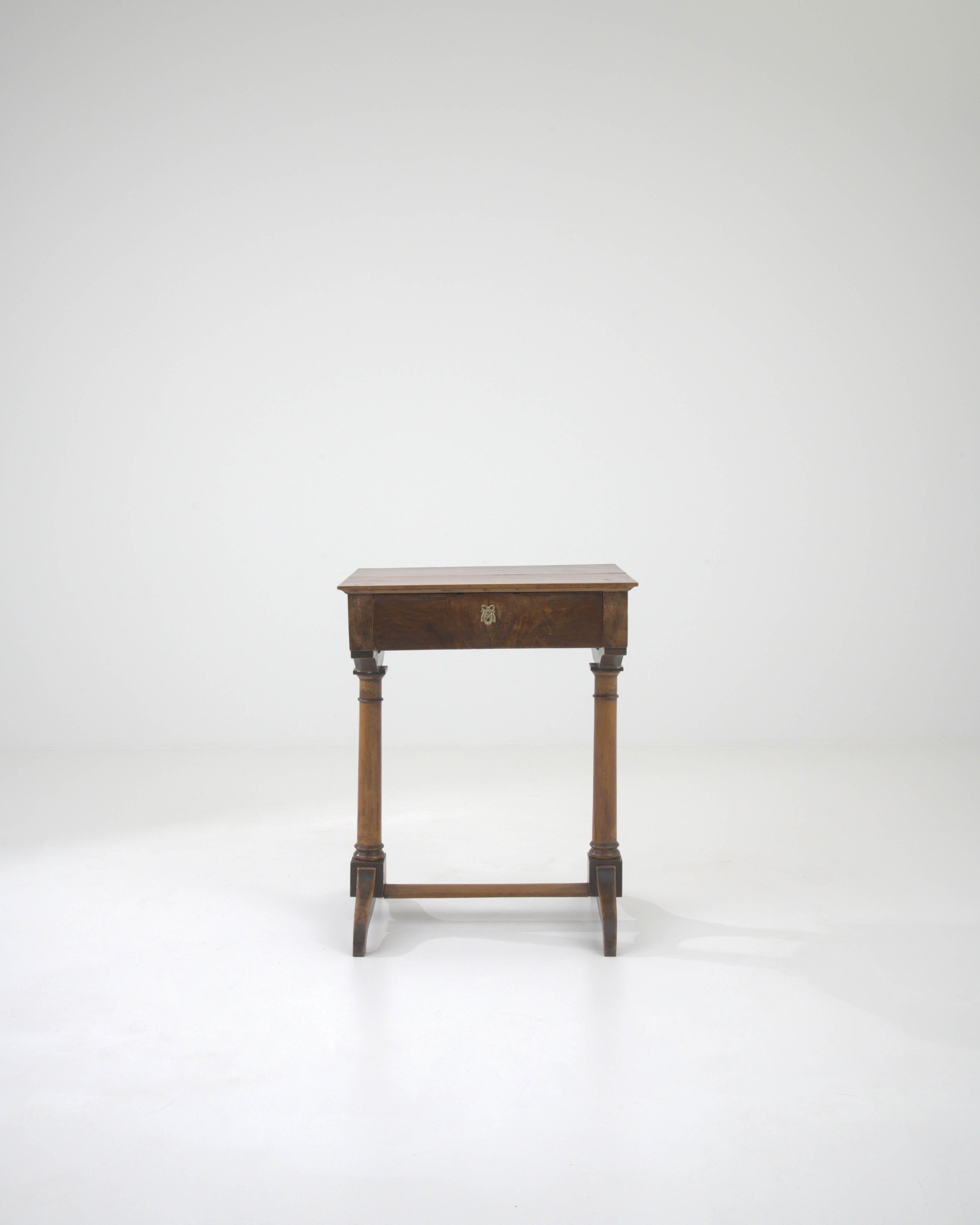 This authentic 19th Century French Wooden Side Table exudes the charm and character that only age can bestow. With its original patina, it tells a story of a bygone era, bringing with it an air of historical elegance to any room. The table stands on