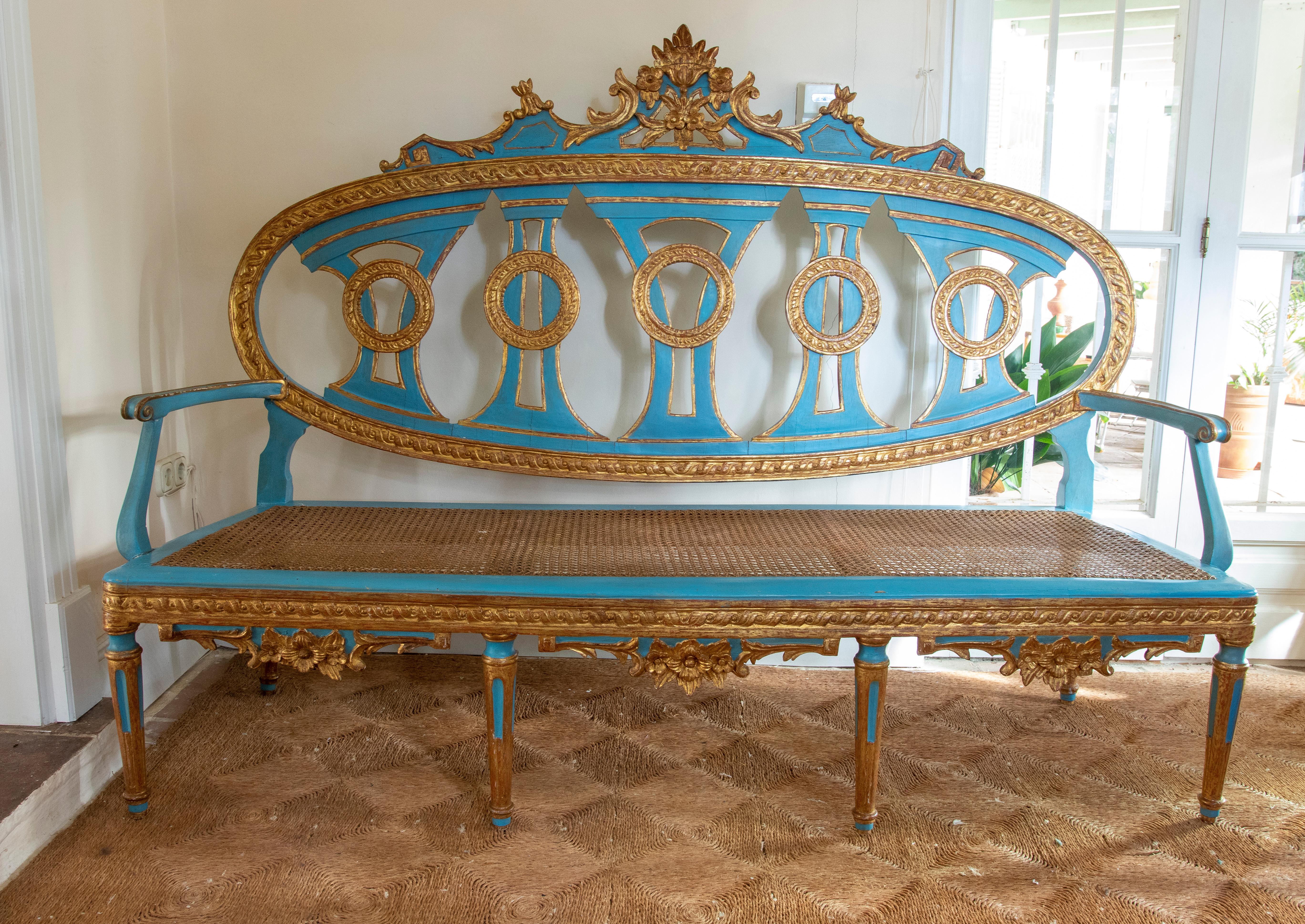 19th century French wooden sofa with wickerwork back and seat.