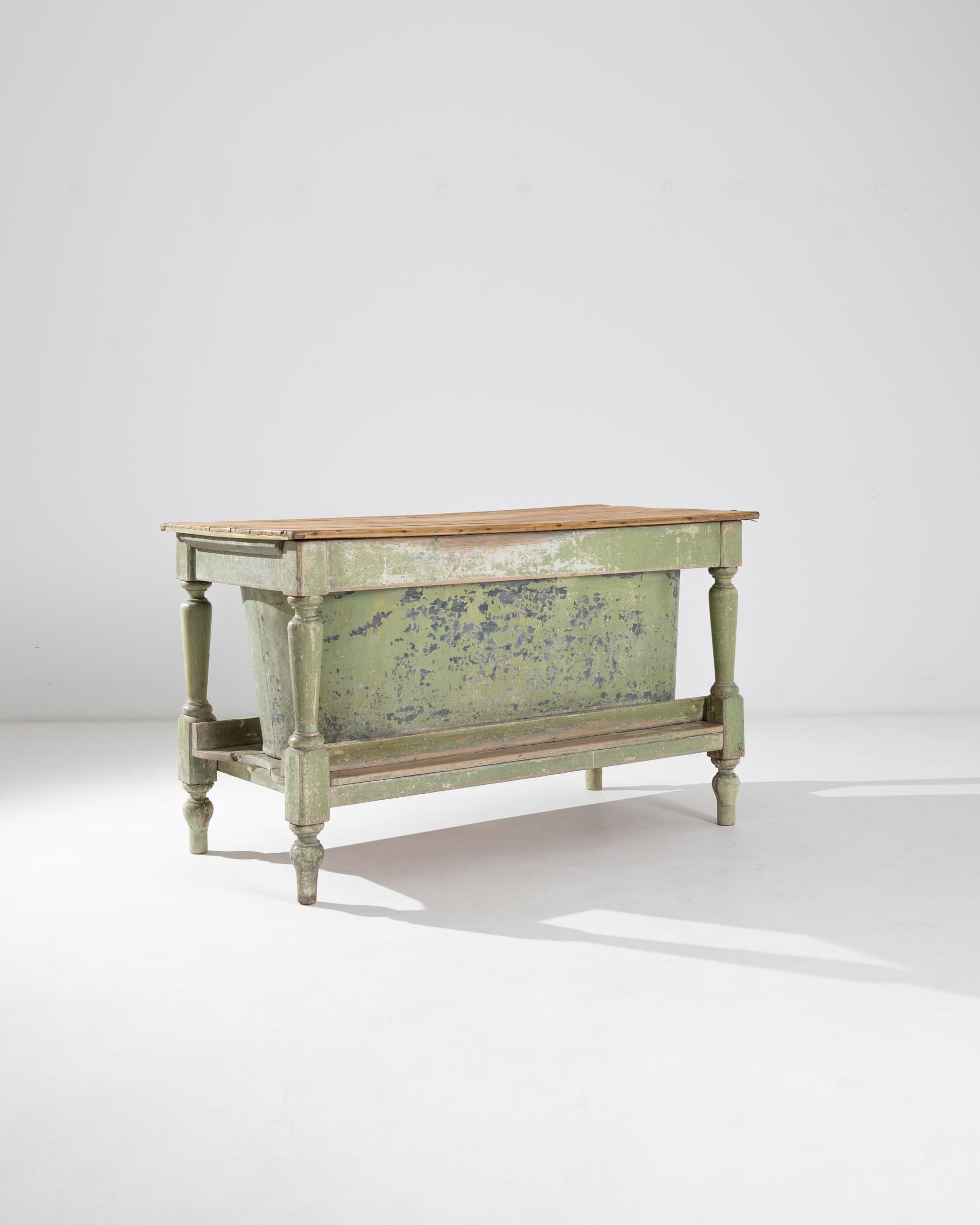 Charming and efficient, this wooden table houses a zinc bathtub beneath a detachable tabletop. Made in France in the 1800s, this piece is a relic of a bygone age when baths were generally only taken once a week, and would have been filled by heating