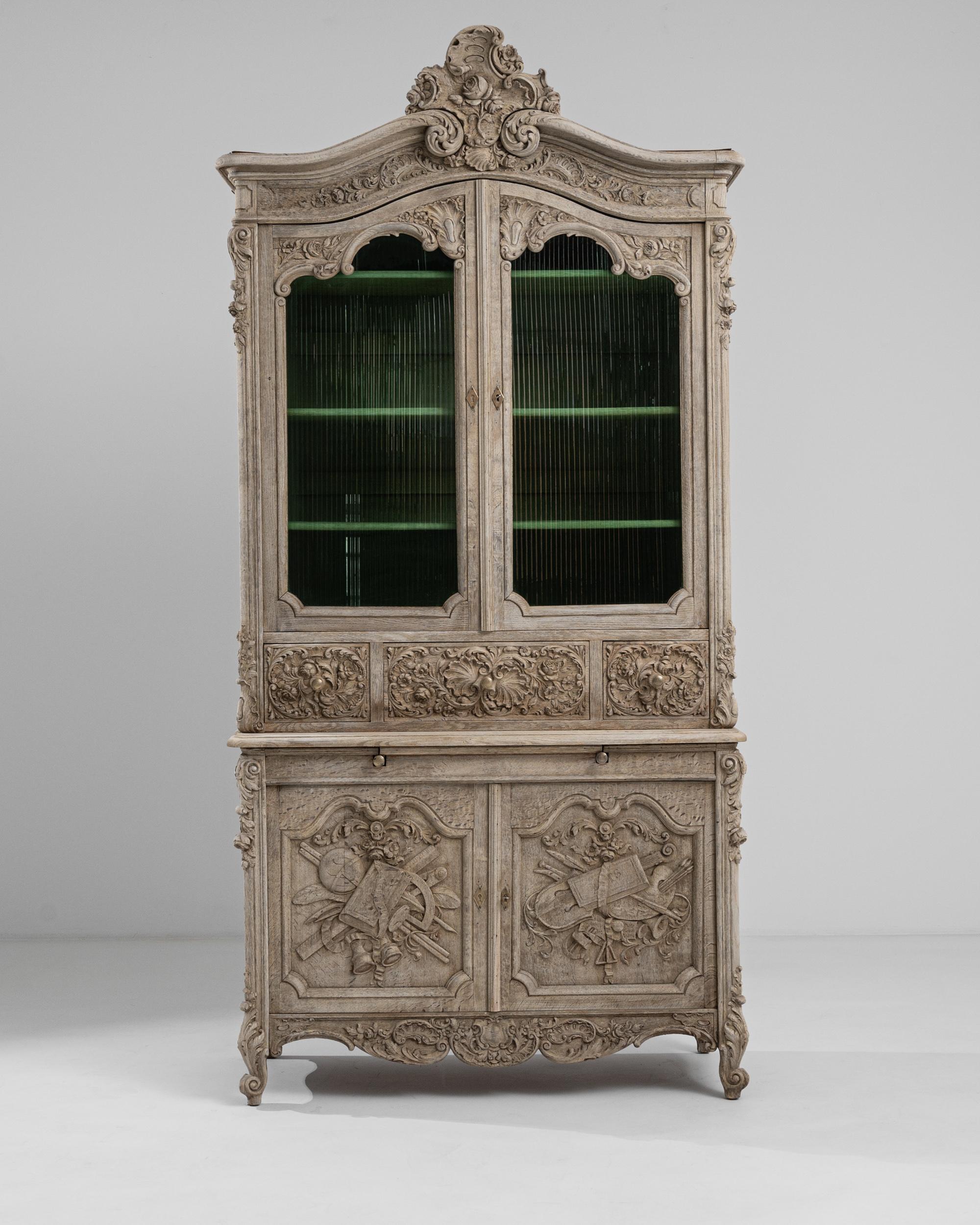 A French wooden vitrine made in 19th century France. A feat of design and craftsmanship, this mesmerizing display cabinet stands tall in impressive regality. This neoclassical-inspired cabinet is composed of four display shelves, several middle