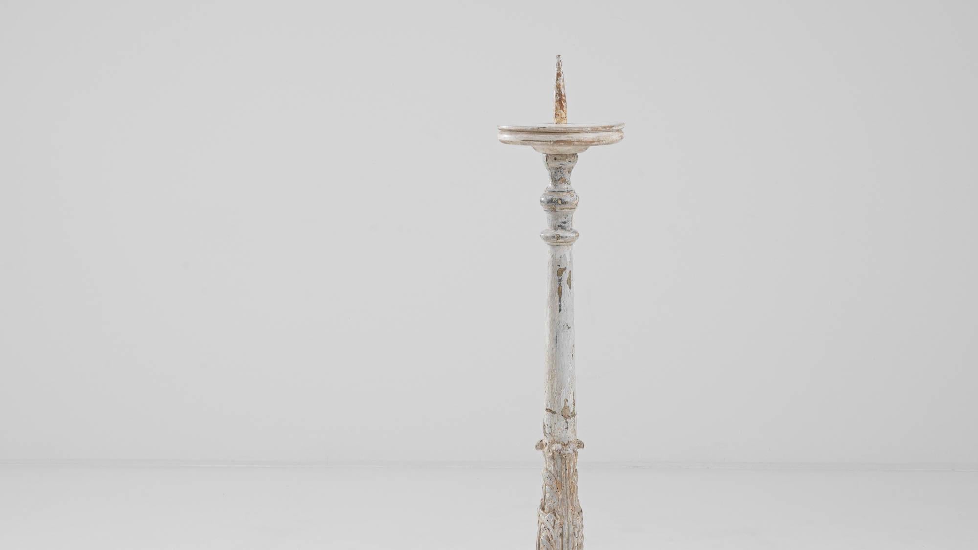 Illuminate your space with the timeless elegance of this 19th-century French Wooden Floor Candlestick. Standing tall at 55.1 inches, this majestic piece commands attention with its stately presence. Crafted from wood and finished in a graceful white