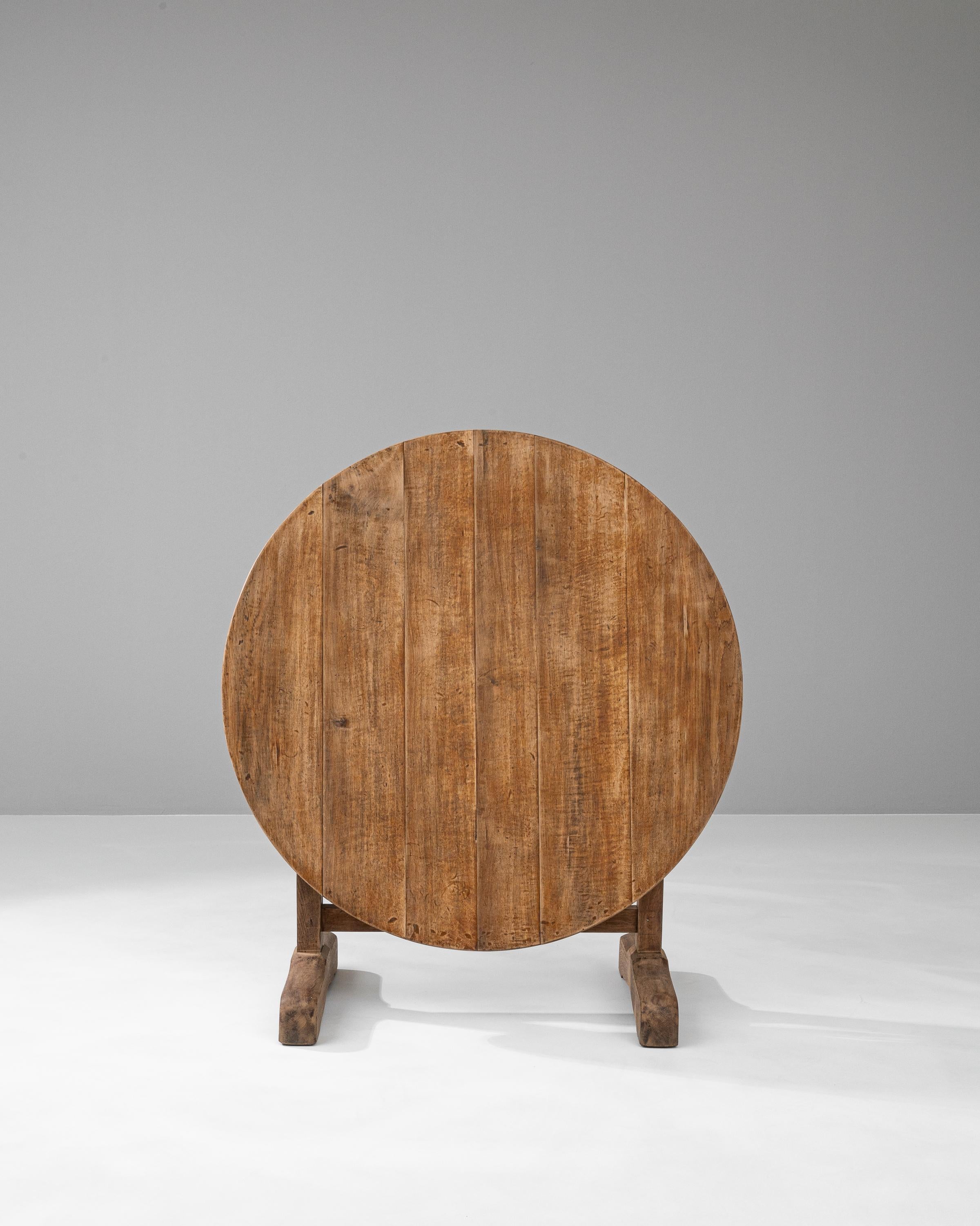 Introducing the exquisite 19th Century French Wooden Wine Tasting Table, a timeless addition to your curated home collection. Imbued with history, this authentic piece was crafted in the era of romantic poets and illustrious artists. Its beautifully