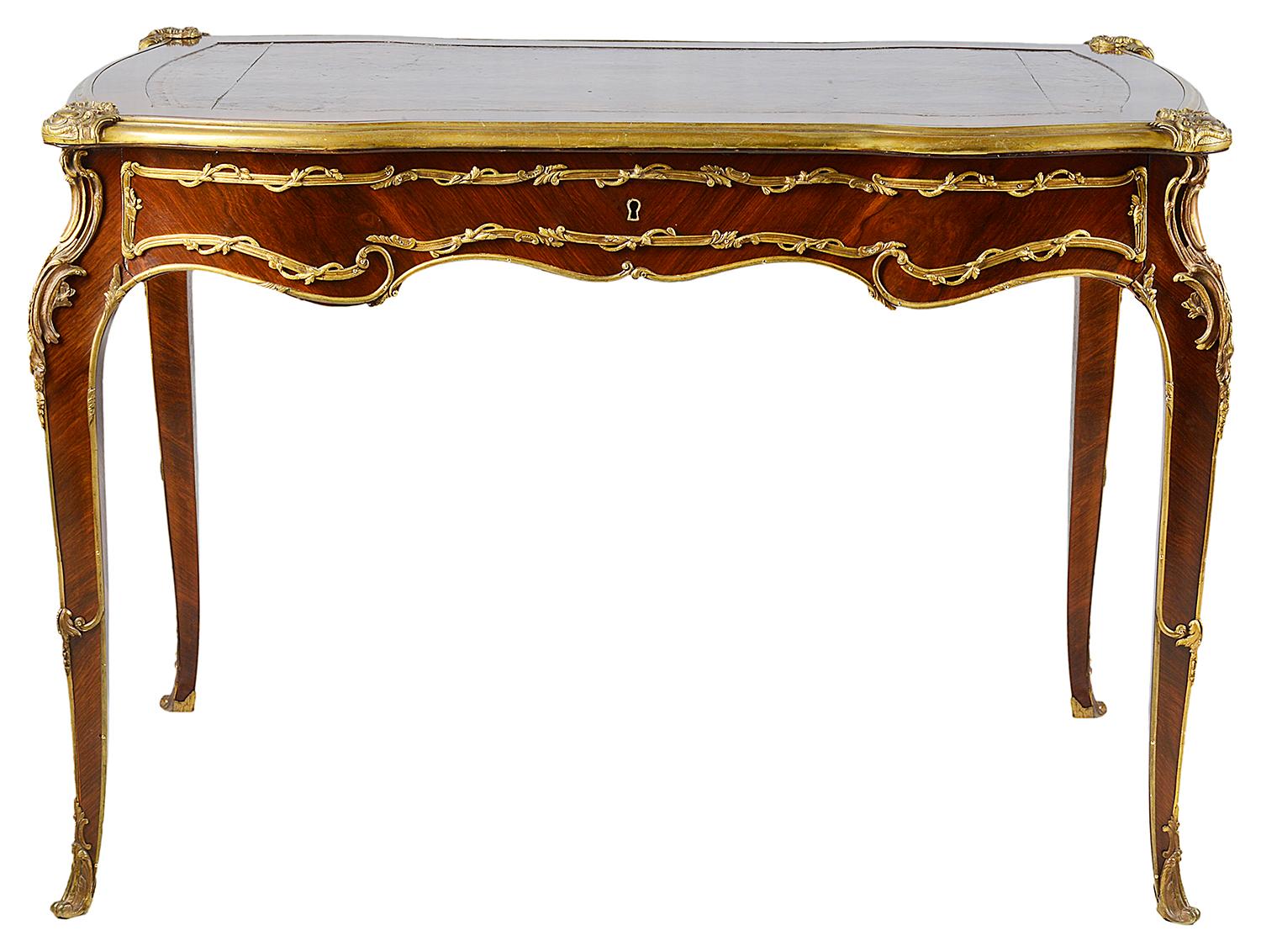 A very good quality French Louis XVI style bureau plat, having an inset leather top, gilded ormolu mounts, a single frieze drawer, raised on elegant cabriole legs terminating in scrolling gilded ormolu feet.
In the style of 'Linke'.