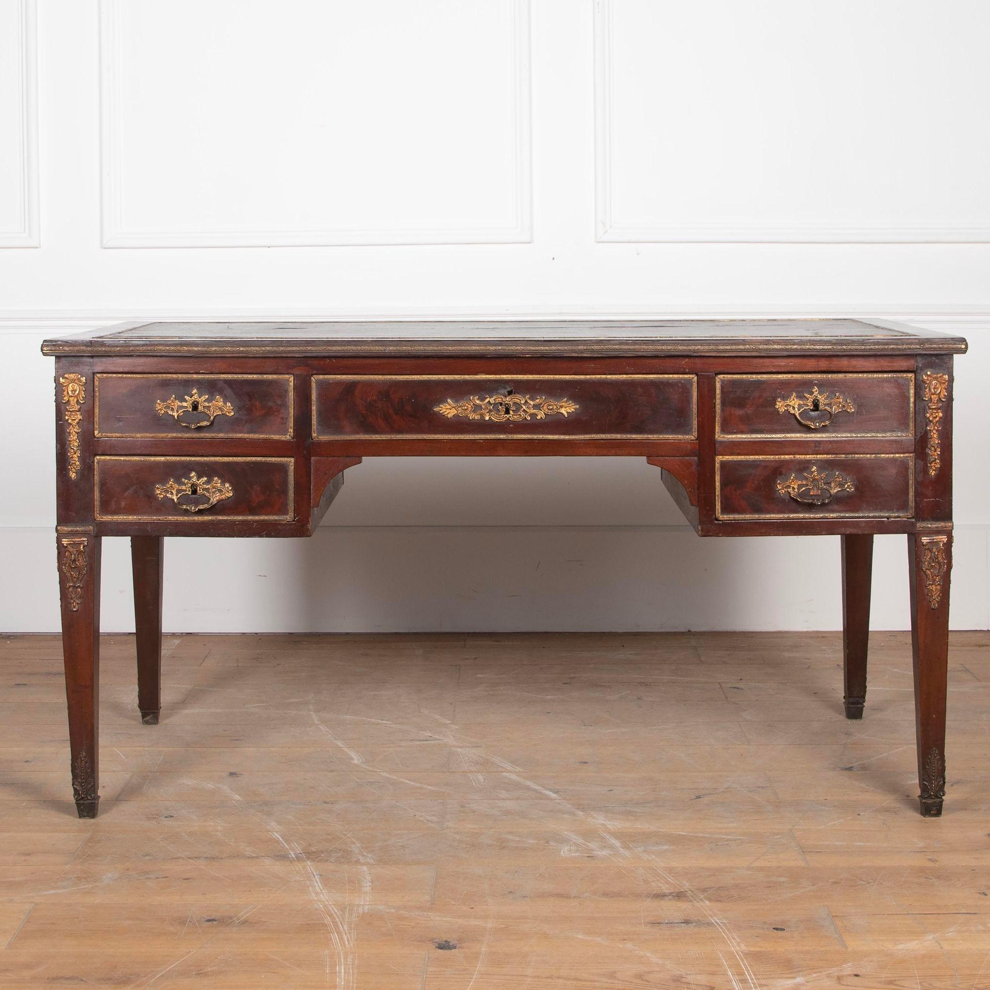 19th Century French writing table with worn leather top and ormolu mounts.
This writing table looks the same on both sides, but the fittings on the back are faux.
It also features two extending slides to either end and several opening