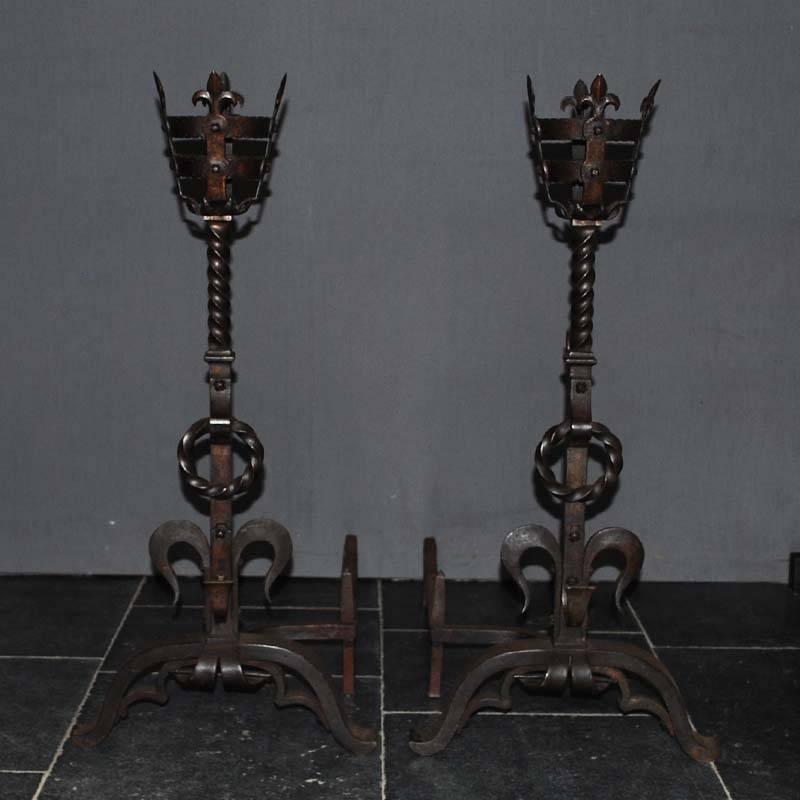 This is a beautiful pair of wrought iron French firedogs forged, circa 1860.
These andirons are perfectly suited for a large fireplace.
They stand upon a tripod with forward arched legs and feature spit racks both on the front as on the back