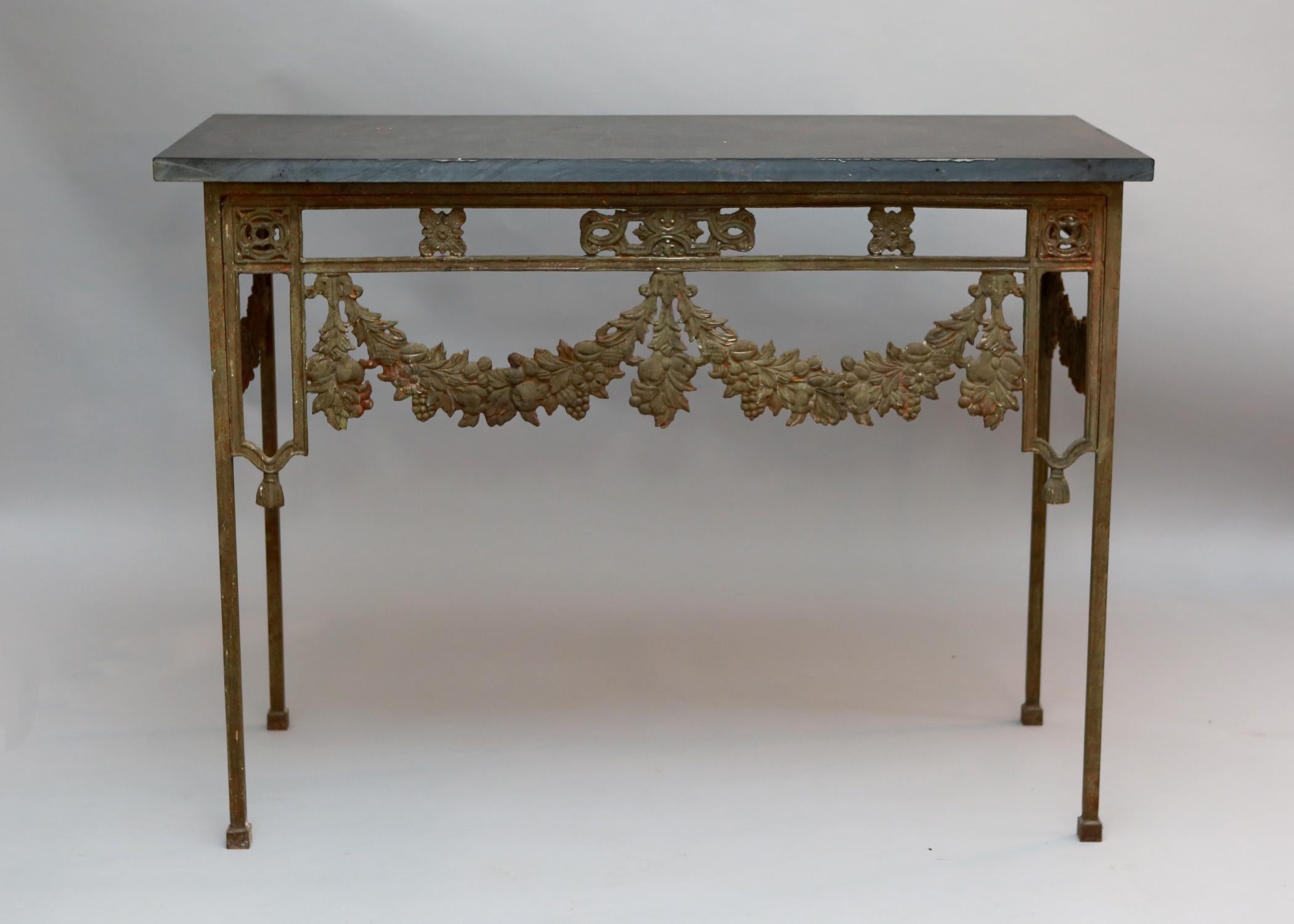 19th century French wrought iron console tables decorated with garlands and swags of floral decoration and original slate tops.