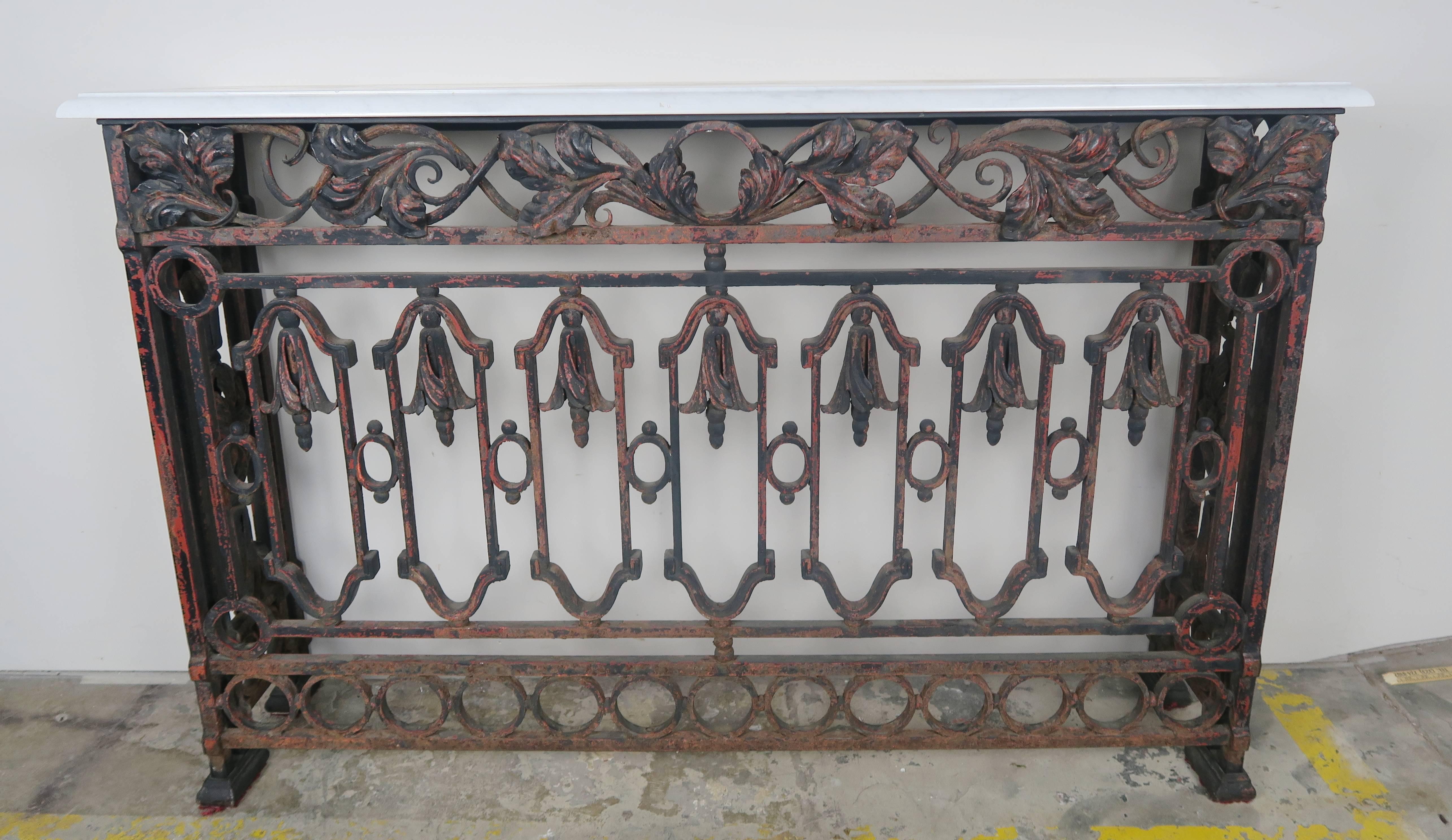 French wrought iron Renaissance style console with Carrara marble top. Remnants of rust paint can still be seen throughout giving the console a beautiful patina.