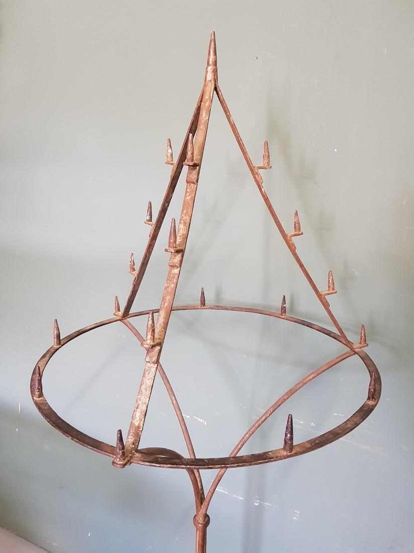 Antique French wrought iron floor candlestick in the shape of a point and it can hold a total of 19 candles, it's standing on a beautiful curled 3 leg and further in a good but used condition. Originating from the 19th century.

The measurements