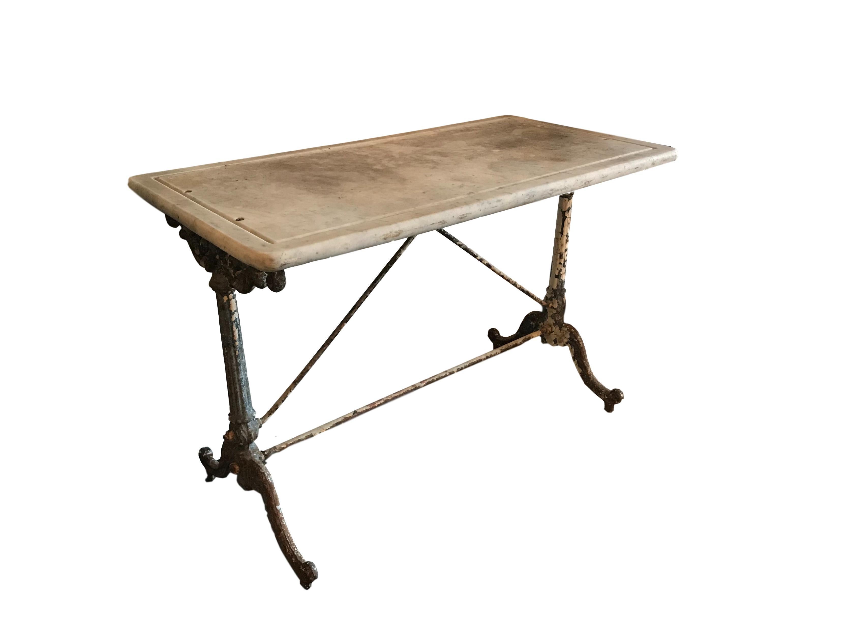 This is a lovely 19th century wrought iron outdoor garden table with its original marble top from France.