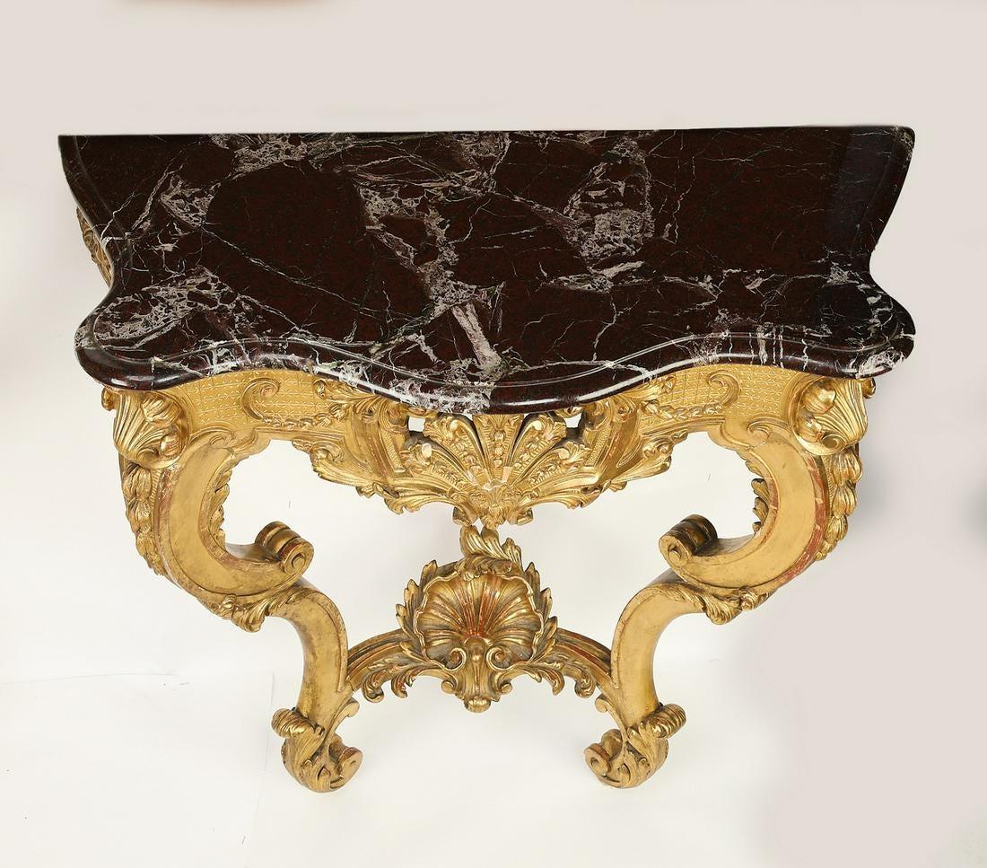 Wall mounted Louis XV style marble top giltwood console table, late 19th century, having a scalloped marble surface rising on the pierce carved apron depicting acanthus leaves and scrollwork, rising on two cabriole legs connected by stretchering