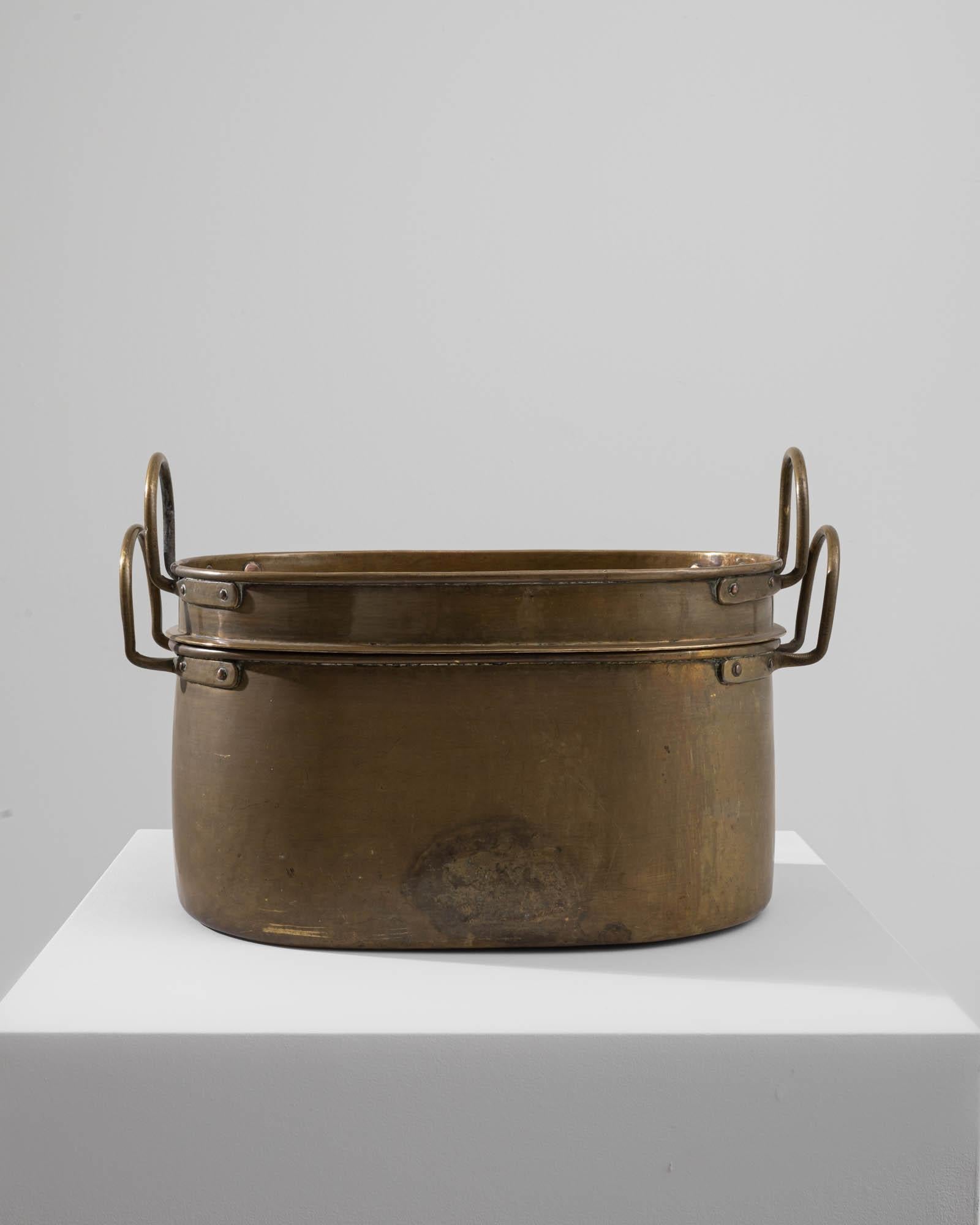A metal pot with a lid created in 19th century France. Expertly crafted, and expelling a sense of articulate design, this unique pot captures one’s attention immediately. With a smaller companion pot, the sharp design sensibility employed in its