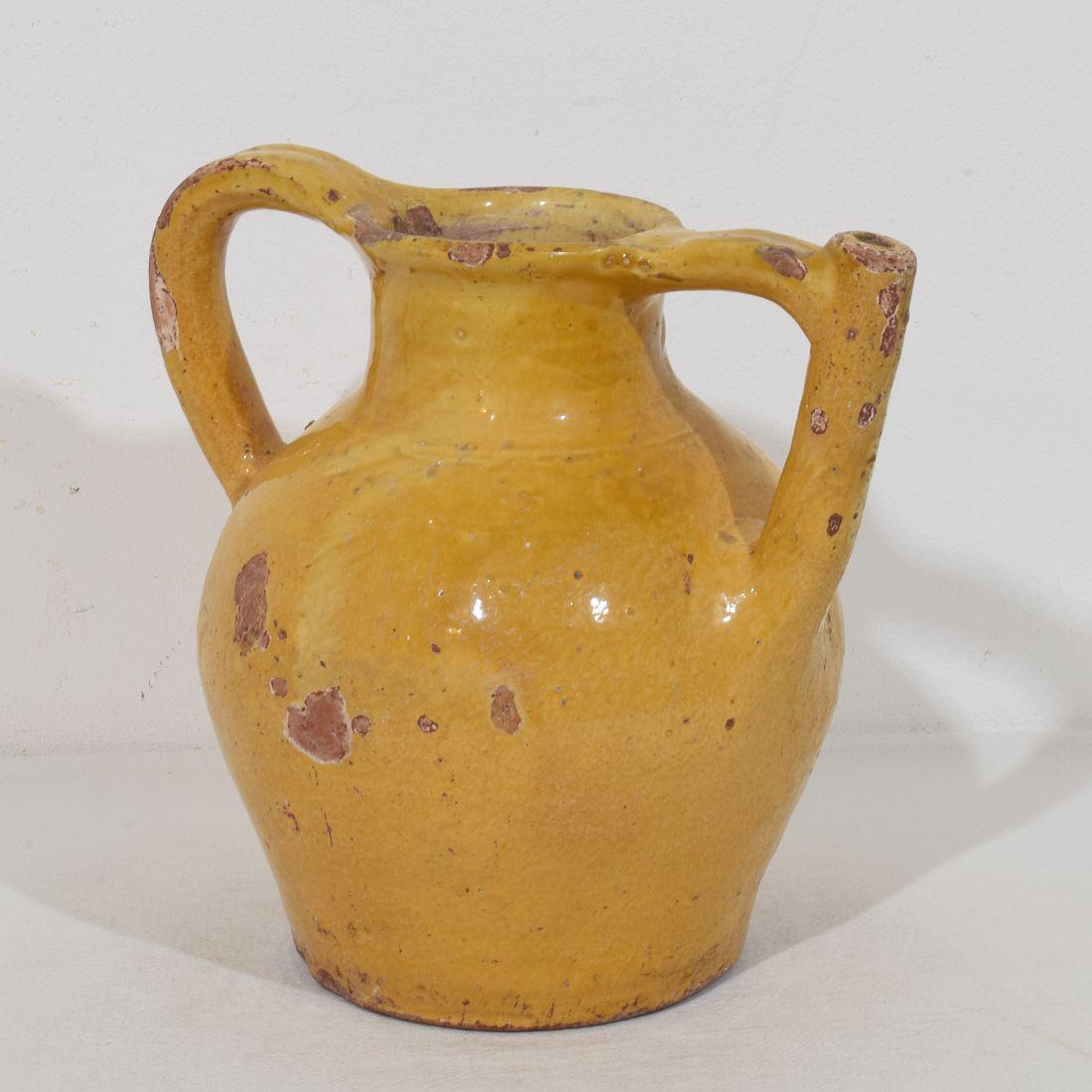 Great authentic and extremely rare piece of pottery with a spout in handle from the Provence called : Orjol du Lauragais. Beautiful weathered yellow glaze. Imperfections help authenticate this water cruche as it was a utilitarian type piece, France,