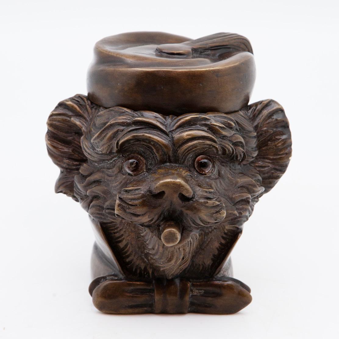 19th century French Yorkie tobacco jar. Bronze Yorkie dog with glass eyes. Smoking a cigar wearing a bowtie and CAP.