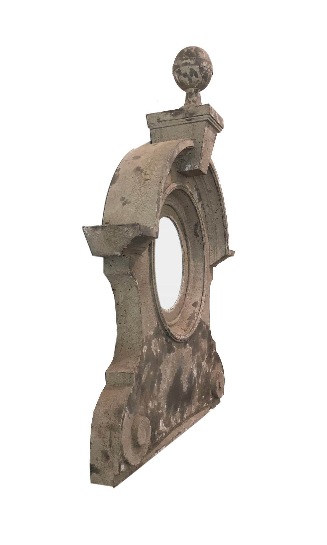 Beautiful and large mansard window architectural element sometimes called and oeil de boeuf, with a mirror added. Large round zinc finial on top and beautiful aged patina. A simpler design than many other mansard windows of its time.