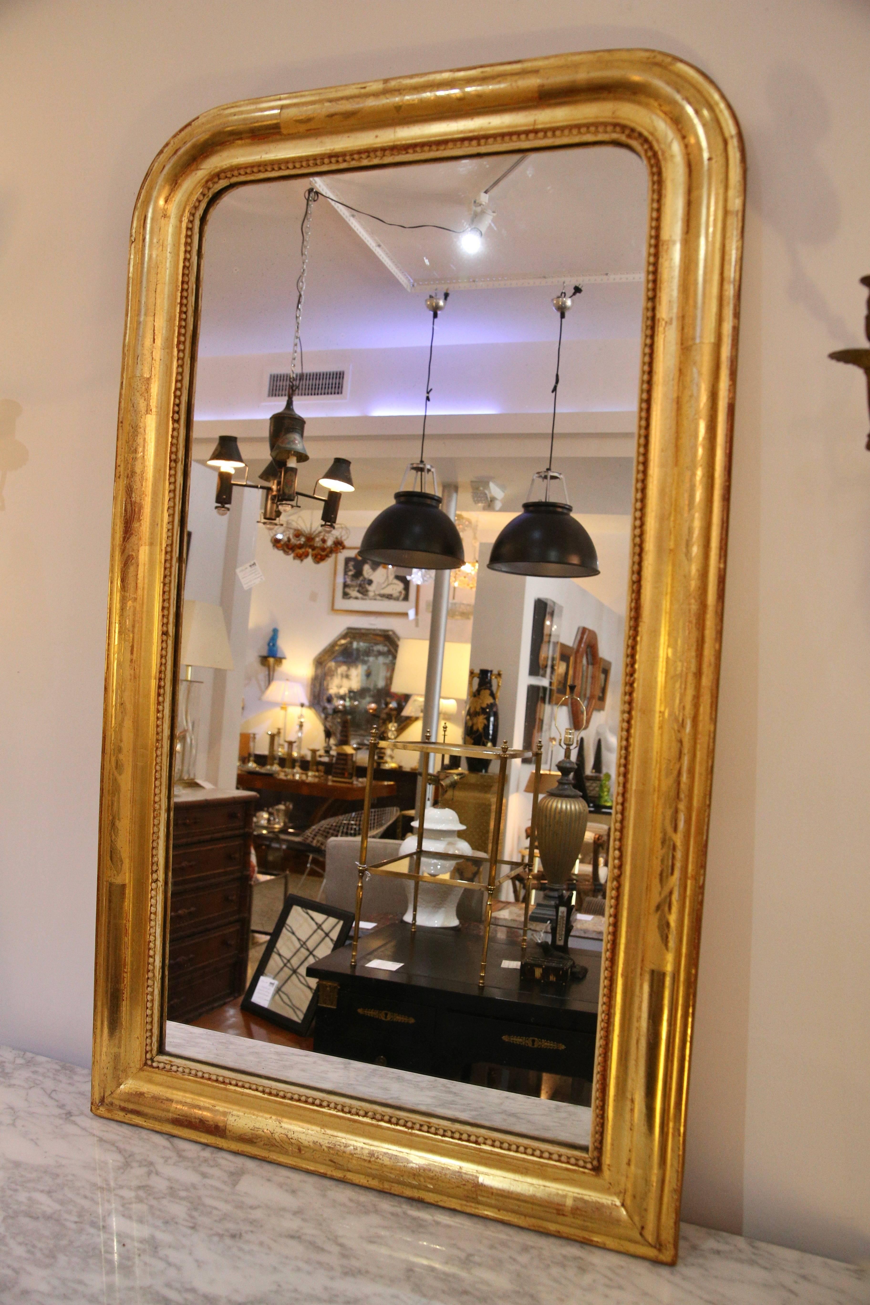 This stylish mirror was recently purchased in London and is in the style of Louis Phillipe of France and dates to circa 1850. The piece retains its original mirror and the gilt gold finish is in near perfect condition with only minimal signs of age