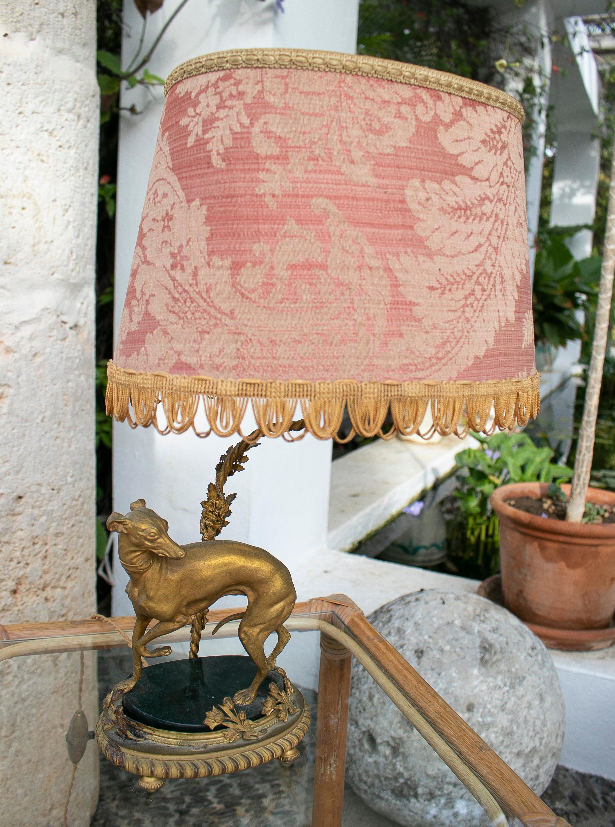 19th century French table lamp with dog in gilded bronze with marble base.