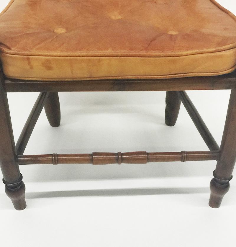 19th Century English fruit wooden child's chair

19th century English child's chair made of fruitwood and has a leather  with buttons upholstered loose seat. 
The chair itself has a rattan seat. It has some traces of use, but it is in good