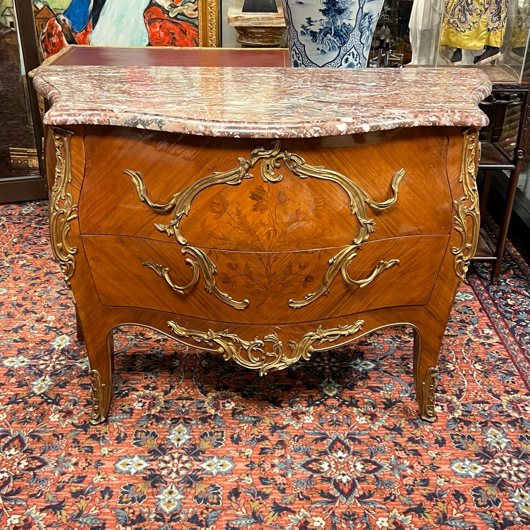 Exceptional antique (late 19th century) French commode in the Louis XV style with fine floral marquetry inlay and gilt bronze mounts.