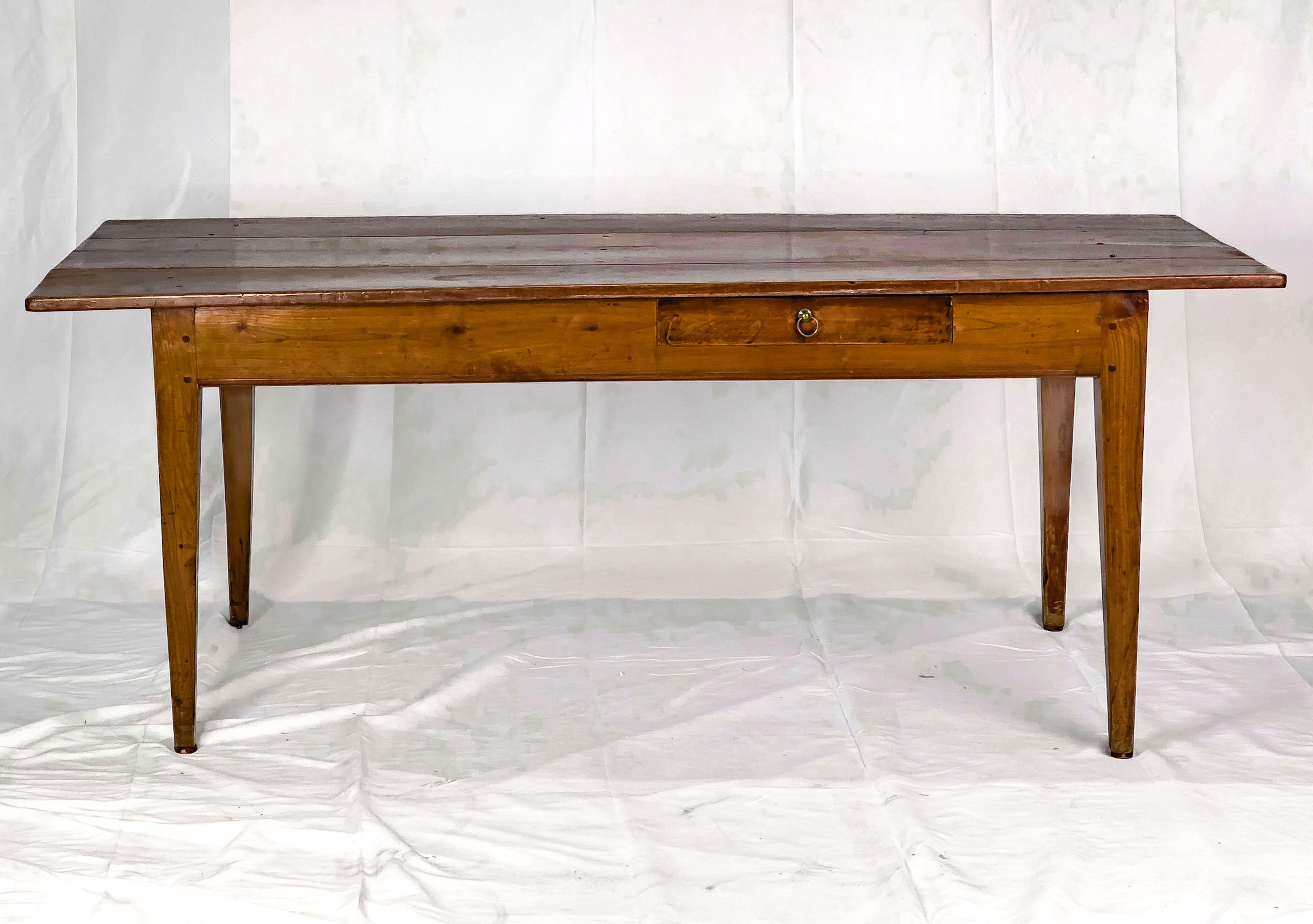 19th Century Fruitwood Farmhouse Table with a plank top, a drawer on one side of the apron and straight tapered legs.  

The table is approx. 28.75 tall
The floor to bottom of apron is approx. 23.5

The legs have all been altered at some point. 