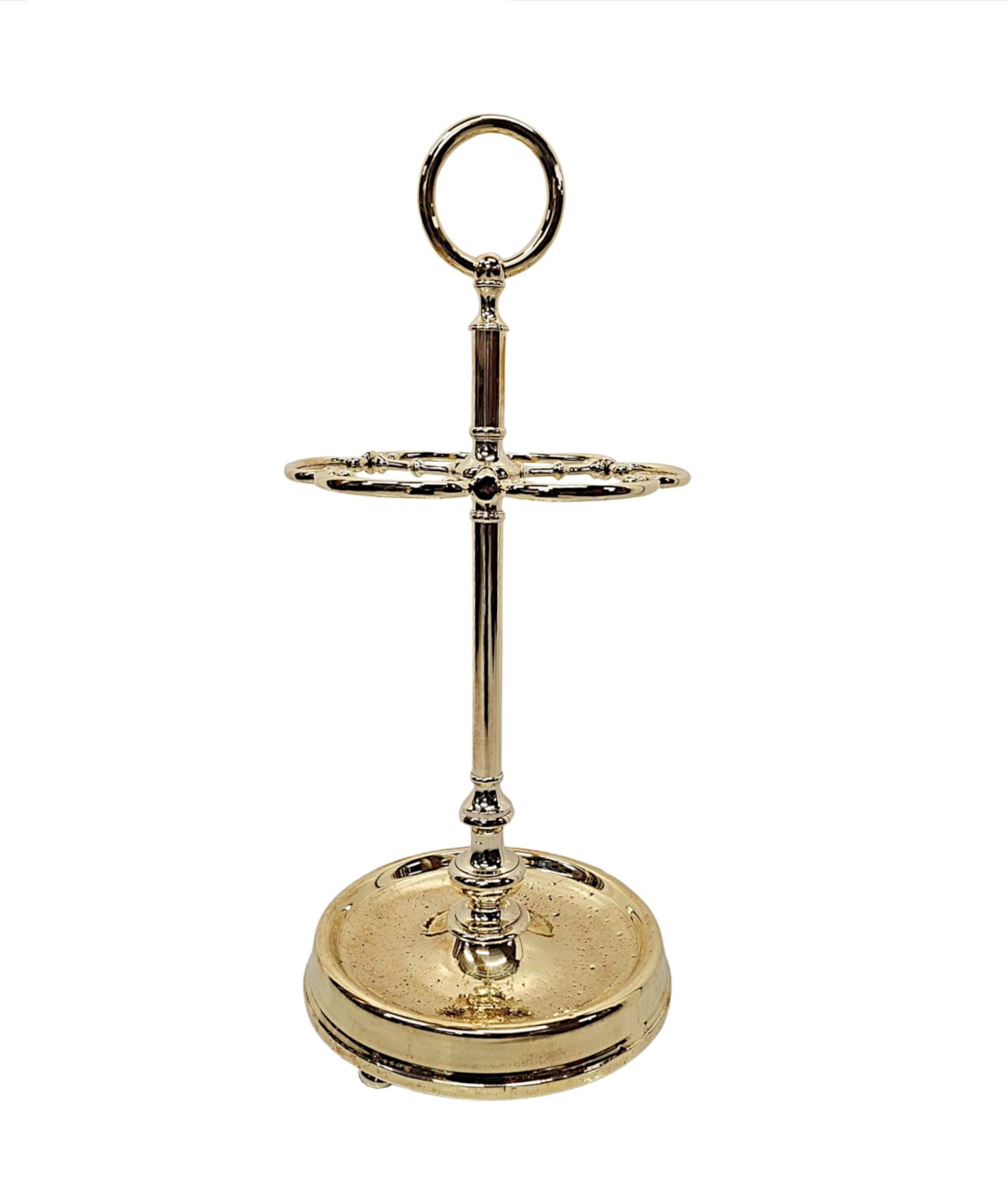 A very rare and fine 19th Century polished brass stick or umbrella stand, fully restored and of exceptional quality.  The finely cast polished brass body of circular form is surmounted with a decorative hoop carrying handle above an elegantly simple