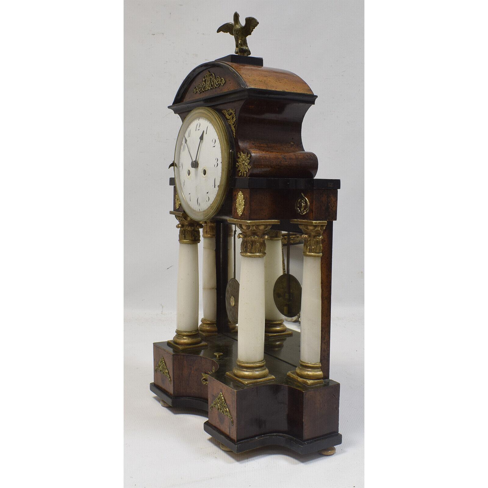 Experience the timeless beauty of this functional 19th-century column clock, an exquisite piece that captures the essence of an era. Standing at a height of 58 cm, this antique mantel clock features a portico supported by four white alabaster
