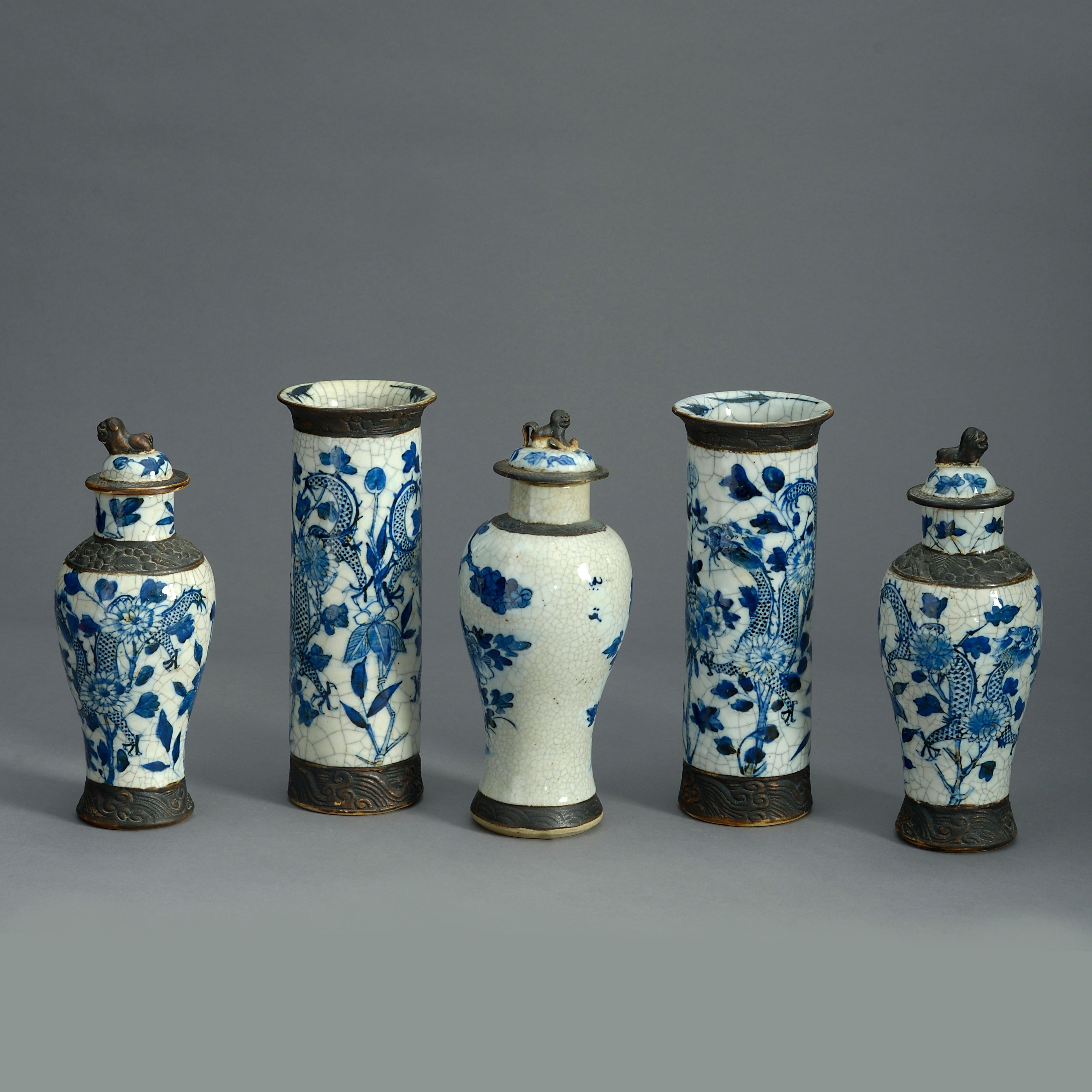 A nineteenth century blue and white and faux bronze crackleware garniture of five matched vases, comprising three lidded and two trumpet vases.

Dimensions refer to tallest vases.