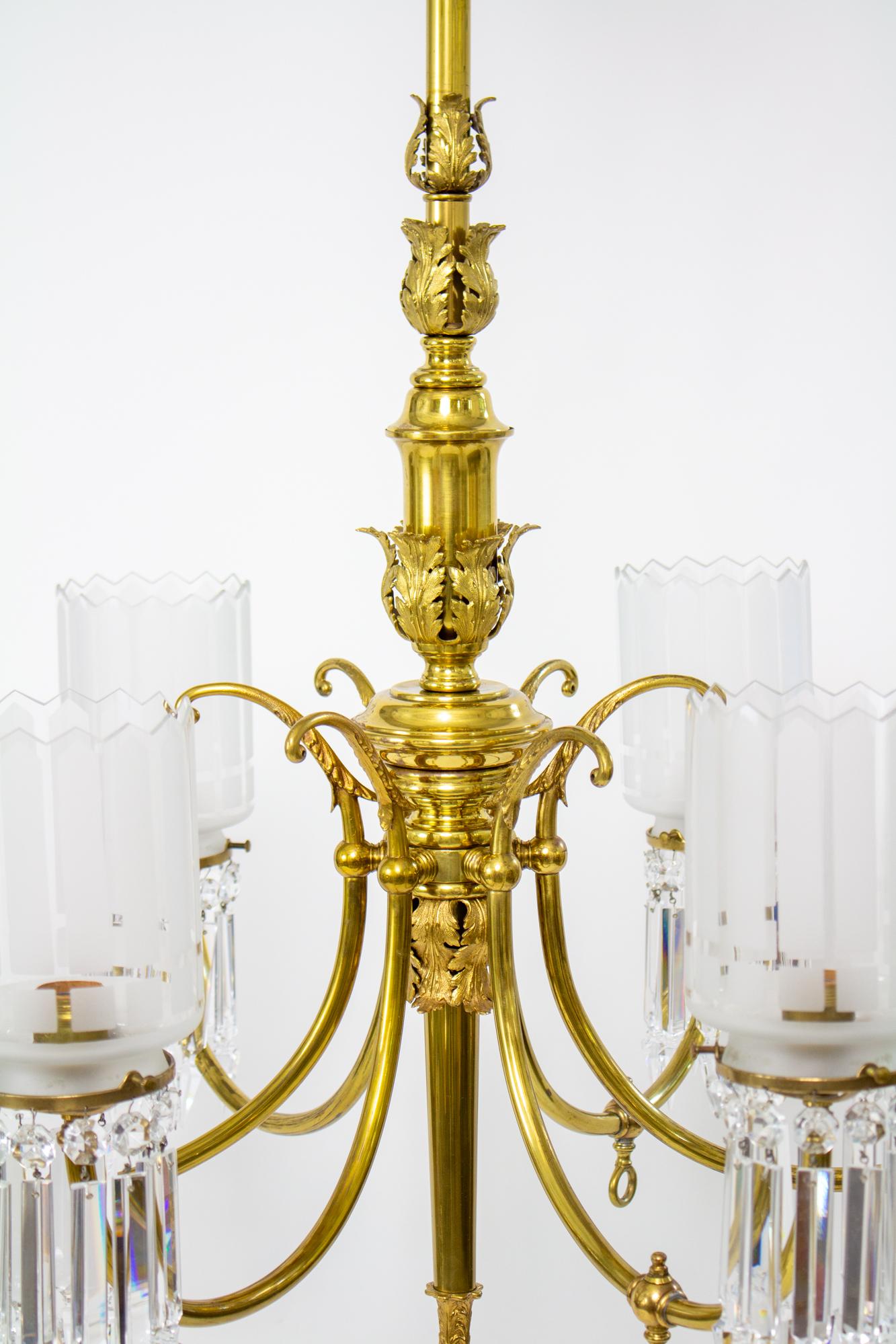 19th Century Gas and Electric Brass and Crystal Chandelier. Brass six light fixture with colonial crystal spears and cylindrical glass shades that reflect the points of the colonial crystals. Six arms, three of which have the original gas cocks and