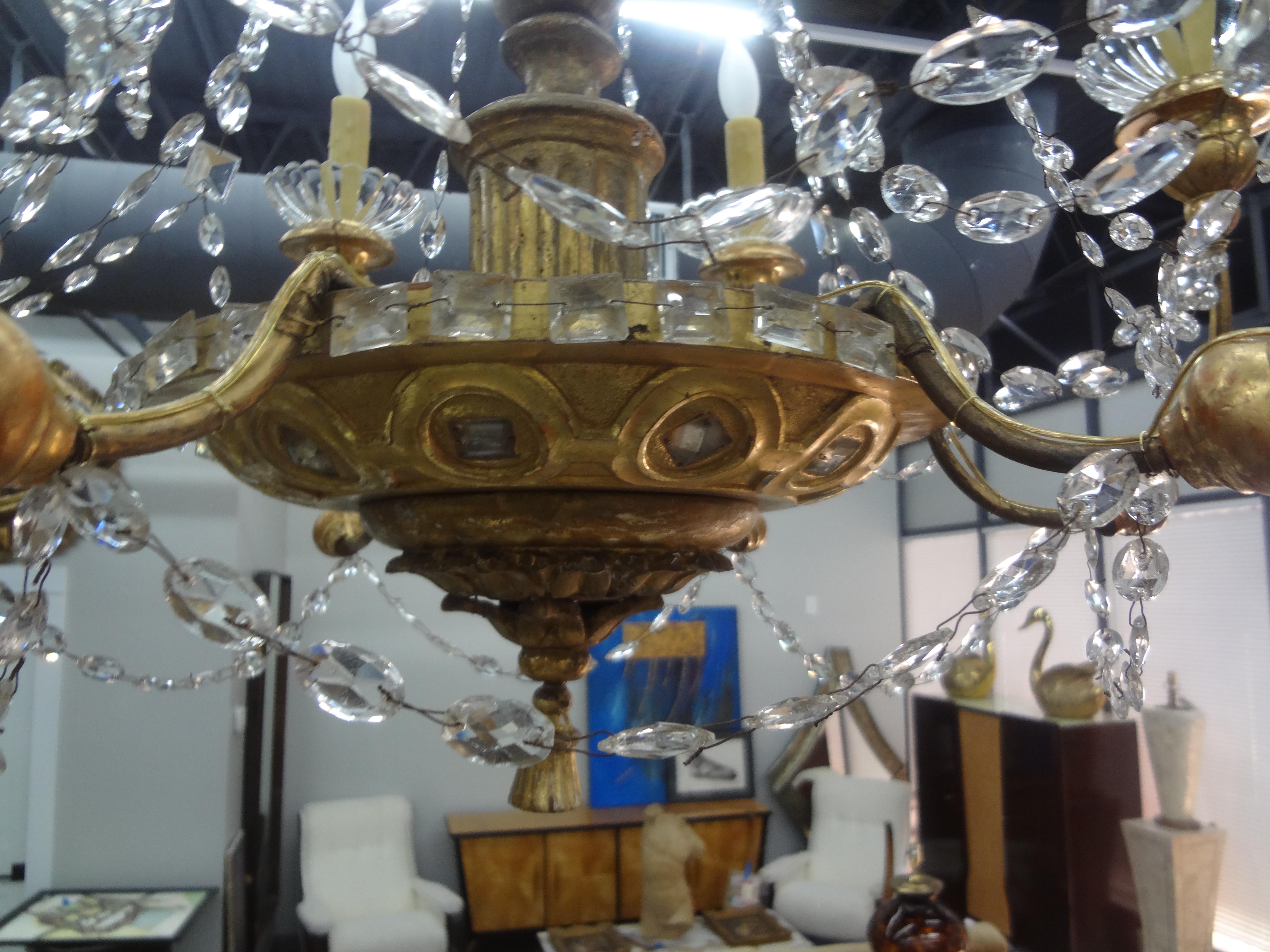 19th century Genovese giltwood and crystal chandelier.
This outstanding antique Italian Genovese gilt wood and crystal six light chandelier has the most unusual mirrored detail with rectangular prisms.
This gorgeous Italian Baroque chandelier has