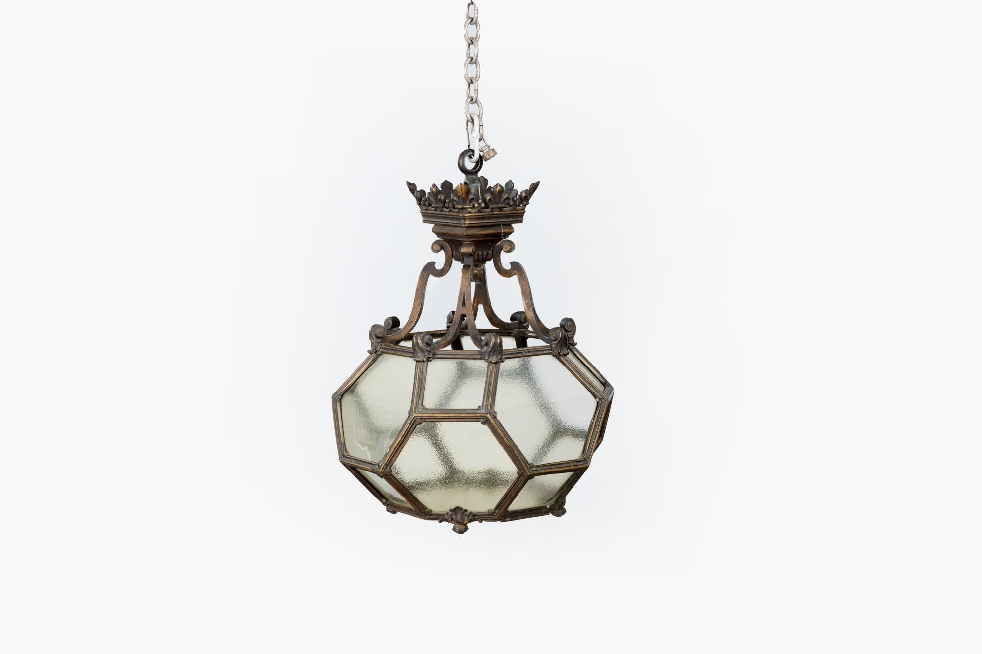 19th Century unusual brass lantern of geometric form. Featuring hexagonal and square glass panels, including a door with a chain locking mechanism. Boasting four scroll arms and trefoil detail to top.