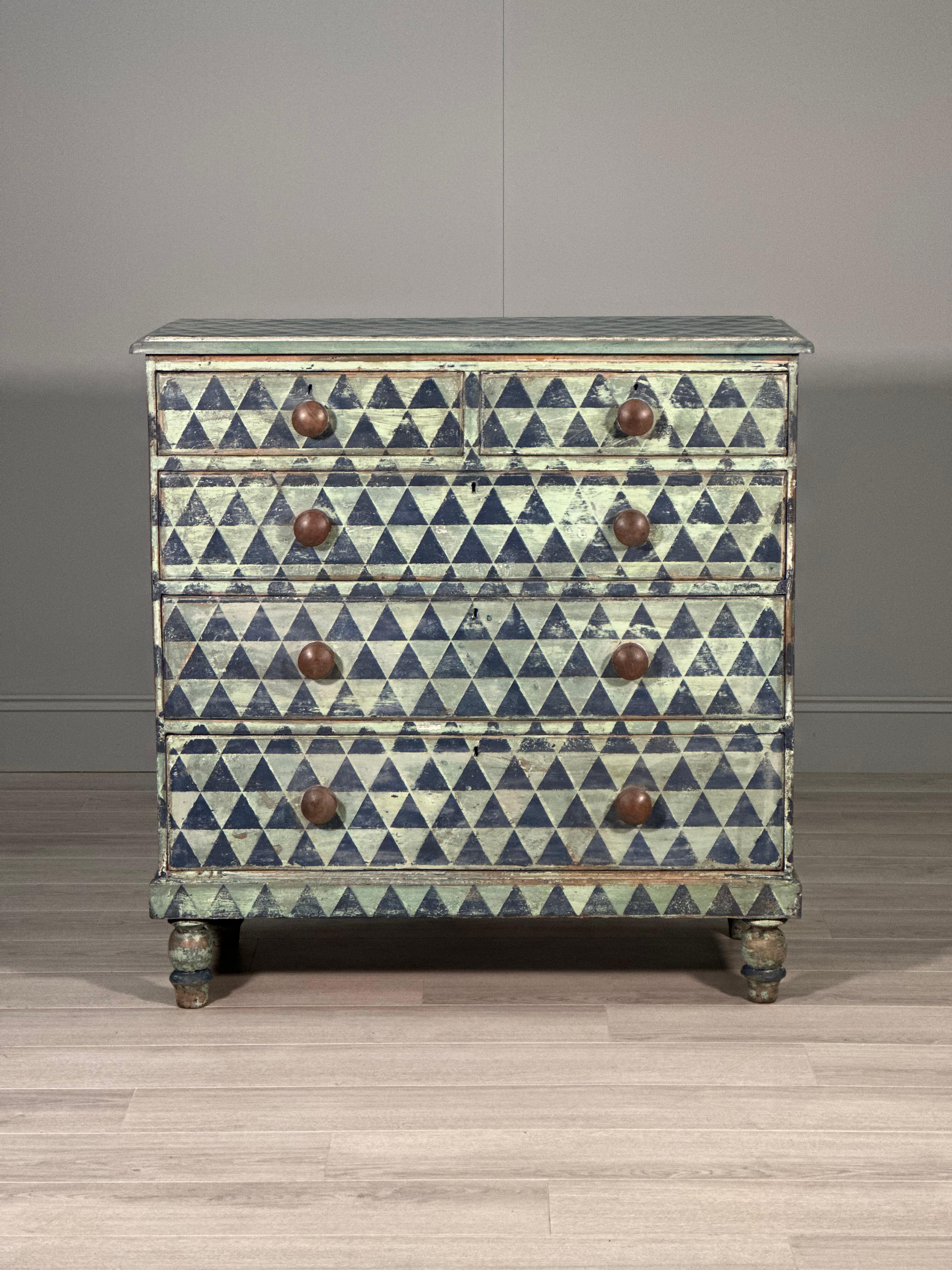 A large chest of drawers dating to the early part of the 19th century and painted in a geometric style. The chest is in very good condition with the perfect amount of wear to the paint.

