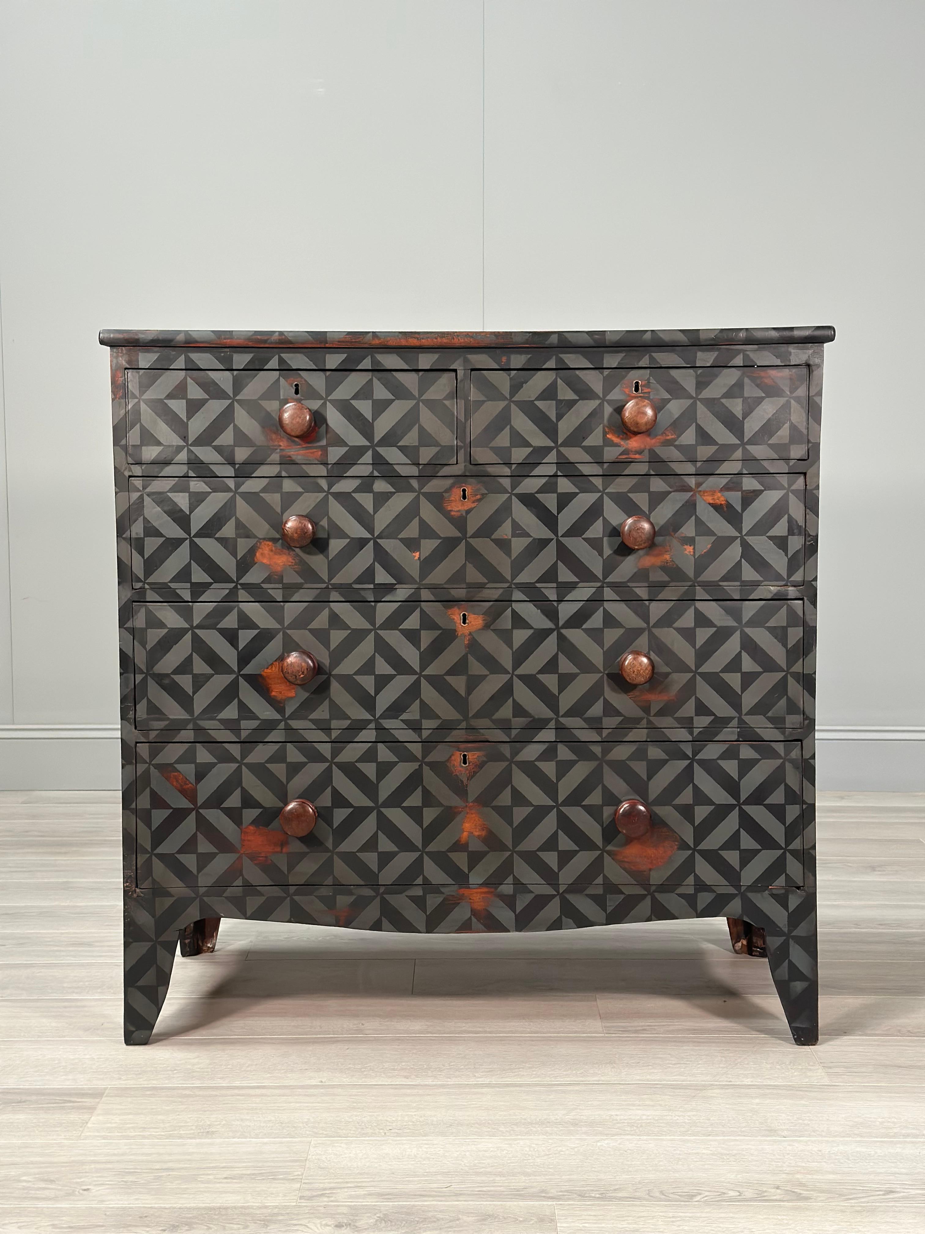 A large chest of drawers dating to the early part of the 19th century and painted in a geometric style. The chest is in very good condition with the perfect amount of wear to the paint.

