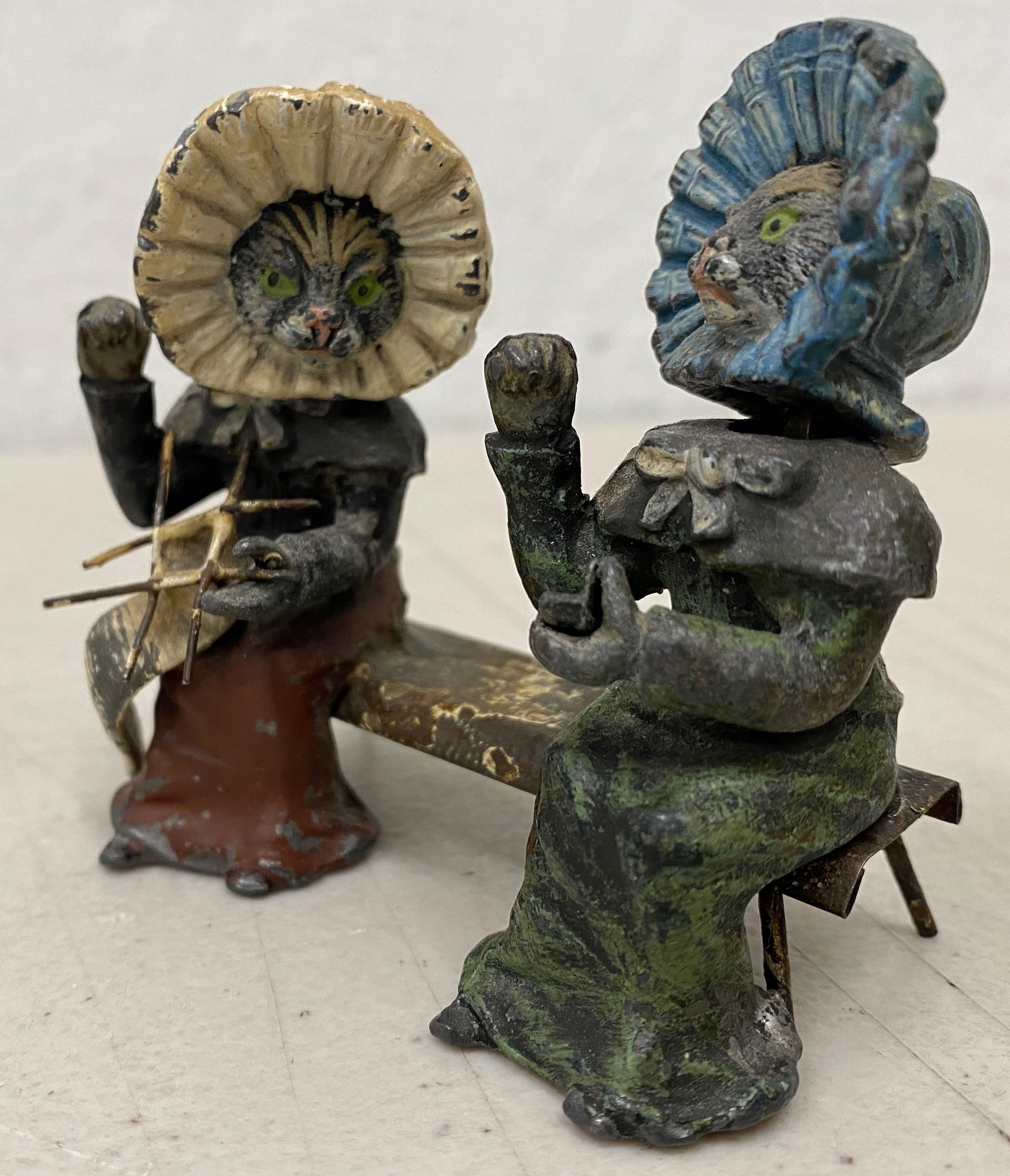 19th century Georg Heyde painted metal cats with shaking heads, circa 1890s

A charming pair of ladies on a bench. One is knitting and the other is holding a small case. Each cat wears a bonnet.

Each cat is hand painted over metal. Good antique