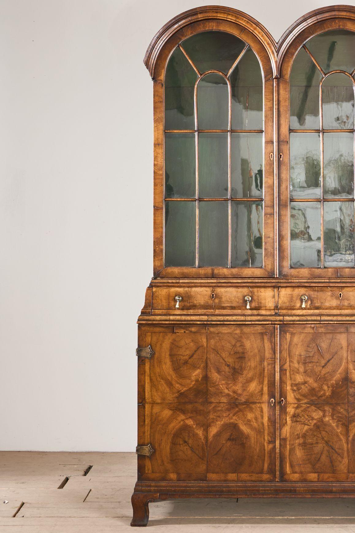 This is a truly stunning and high quality 19th century cabinet in the George 1st style. Made from walnut with gorgeous oyster veneer door fronts. This technique shows how much attention to detail was taking when making this piece. The double arched