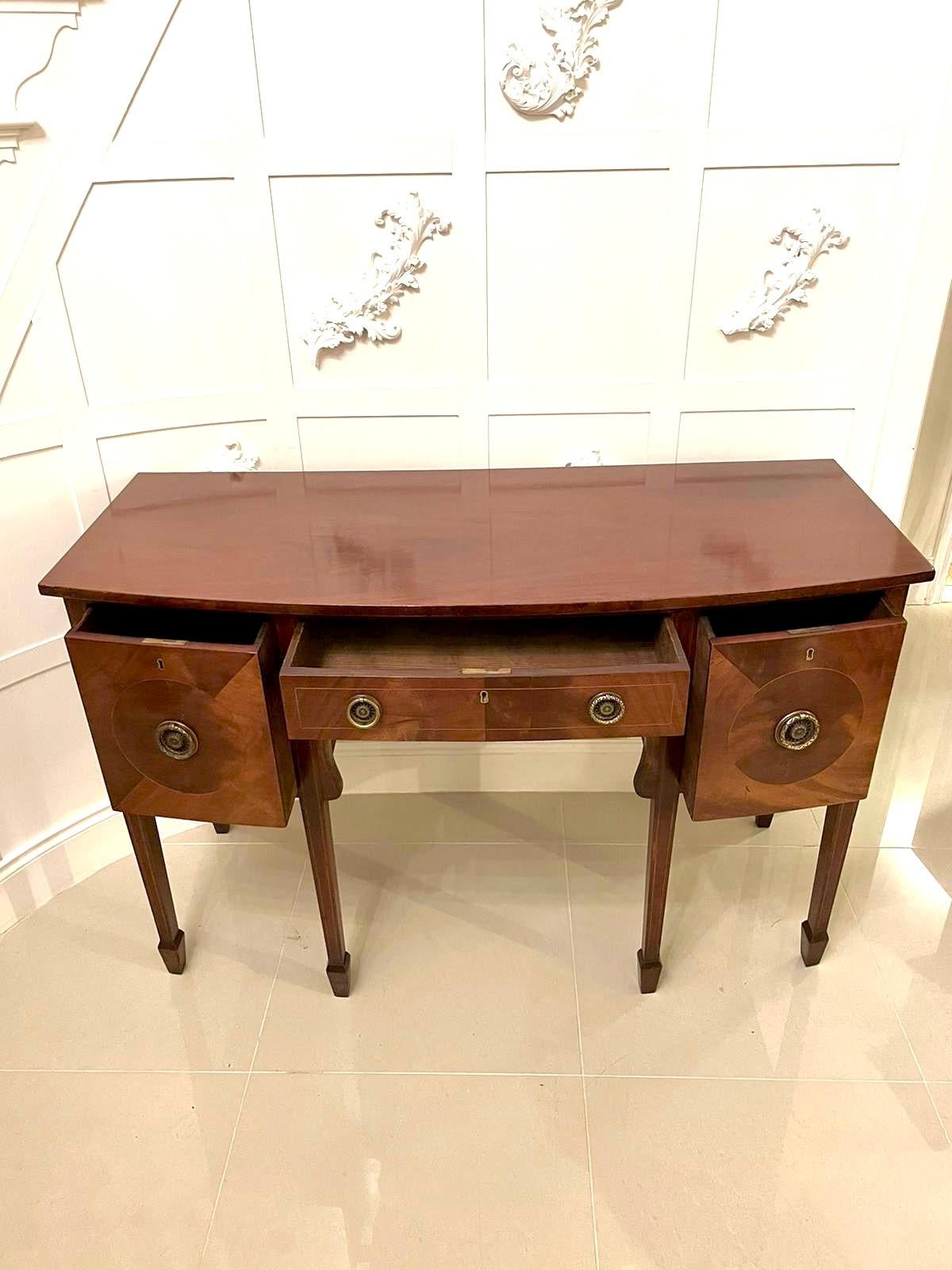 19th century George III antique mahogany bow fronted sideboard having an impressive quality mahogany top, one long bow fronted drawer to the centre with original brass handles and standing on six elegant square tapering legs with spade feet.

A