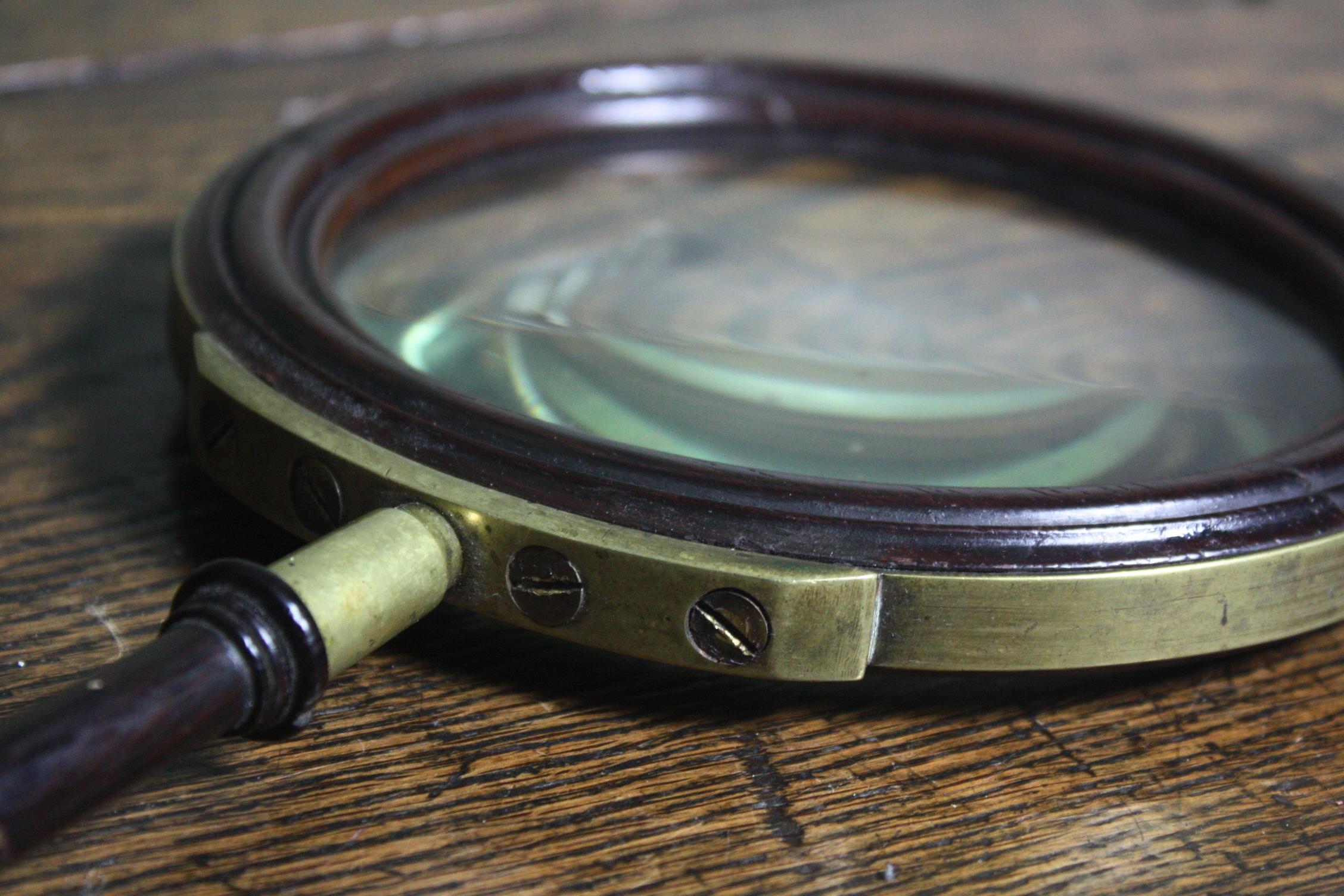 A mahogany and brass bound gallery lens, circa 1820 in age, English in origin. The piece is in all round good condition, some stabile splits, some elderly repairs, general wear to the brass, the lens has some minor wear or scuffs and two small