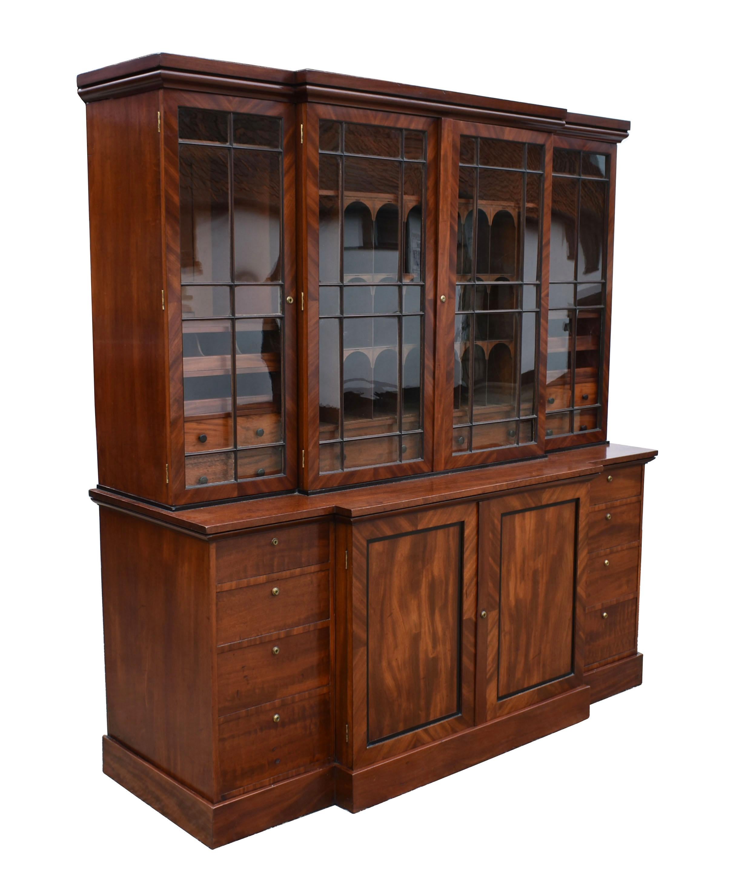 For sale is a top quality George III mahogany breakfront bookcase. The top of the bookcase has flour glazed doors, each opening to reveal a fitted interior. The centre doors open to display various pigeon holes over several drawers. Each side door