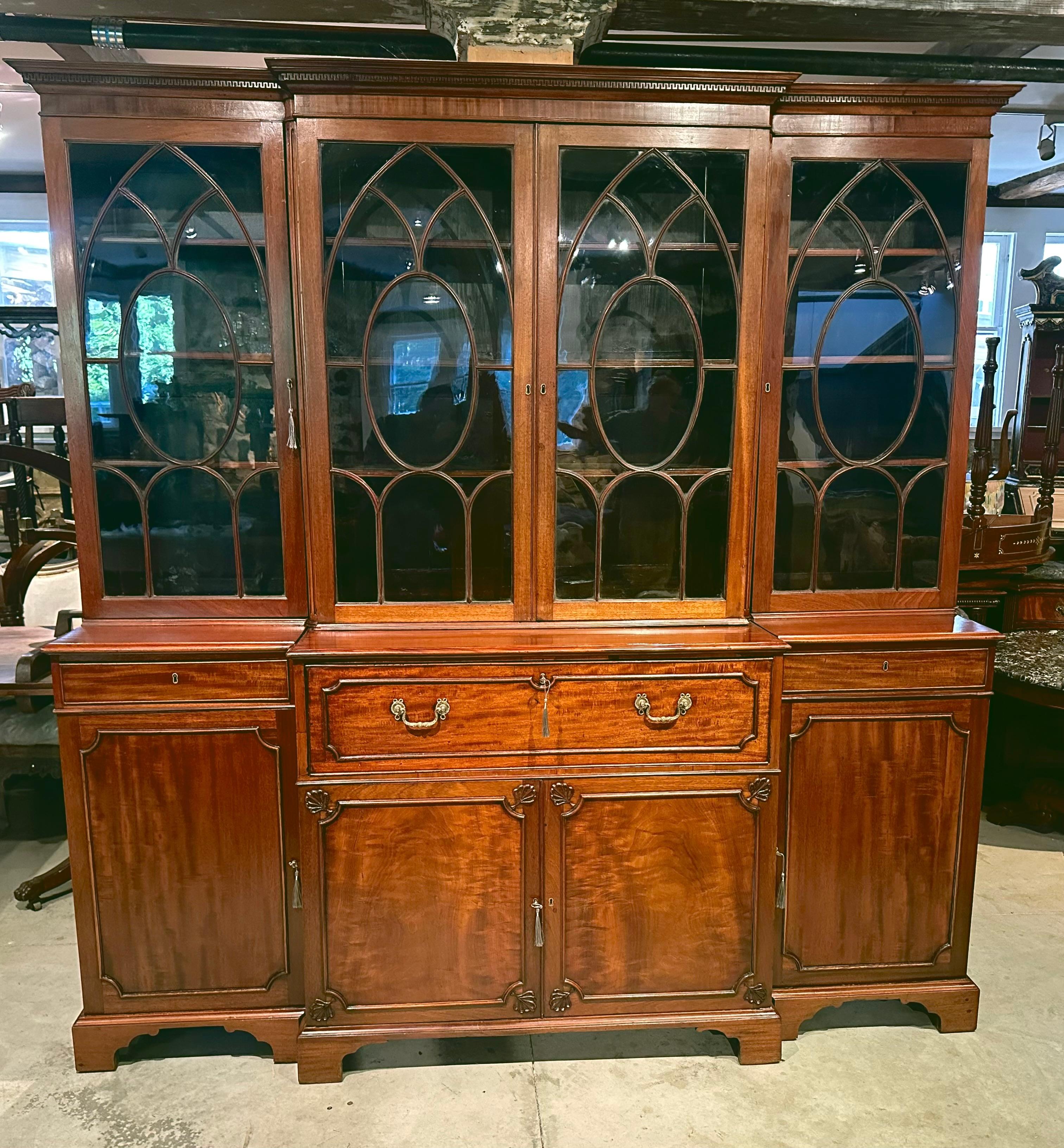 Period George III Mahogany Breakfront Bookcase.  Beautiful Georgian Fenestration.  Base Cabinet Opens to Reveal a Satinwood Writing Interior. Original Linen Slides Underneath.  Nice Color and Patina.  

Provenance: Beacon Hill Family 