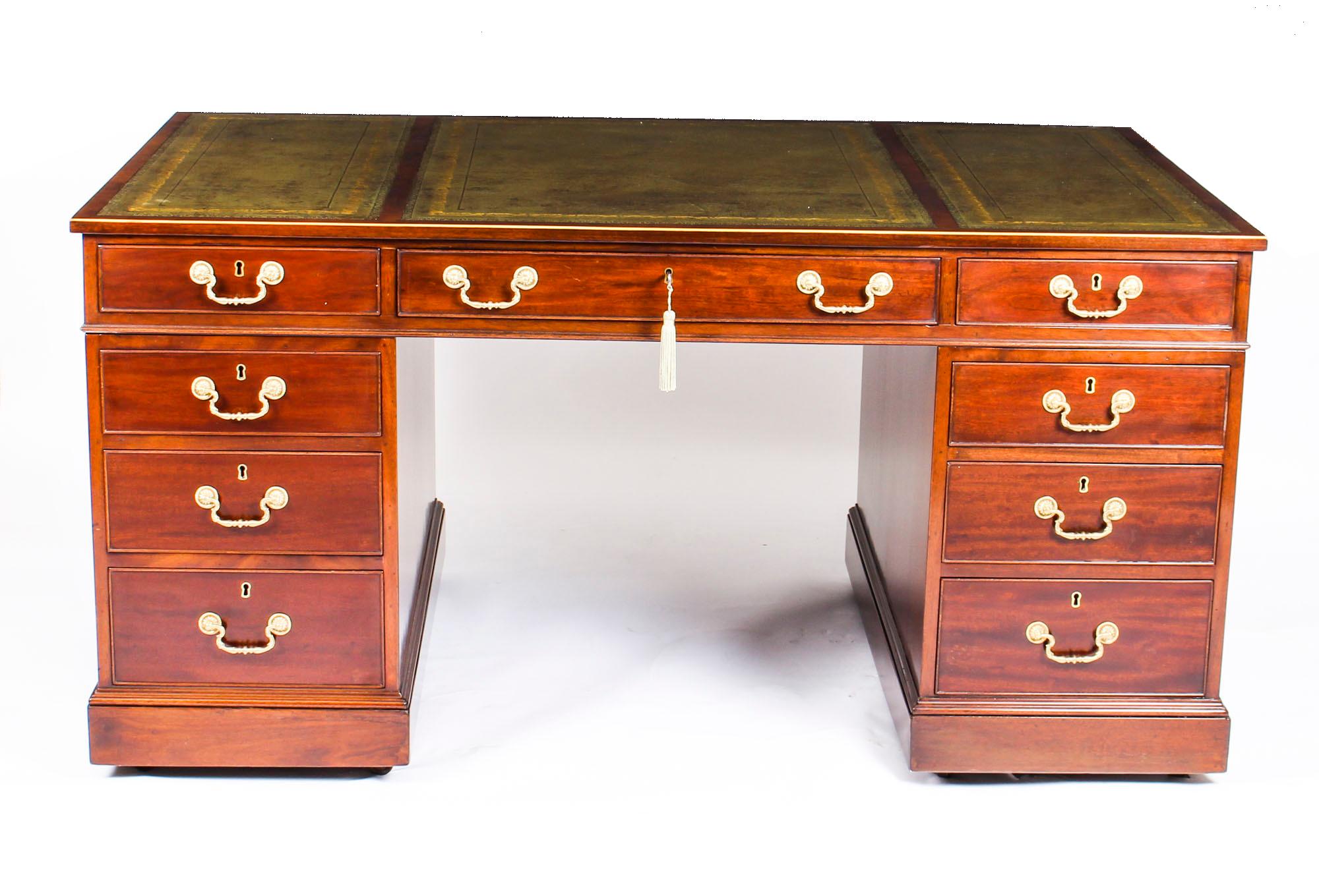This is a beautiful antique George III mahogany pedestal desk, circa 1820 in date.
 
The rectangular top features boxwood stringing to the edge with an inset green and gilt tooled triple leather writing surface, above three frieze drawers and a