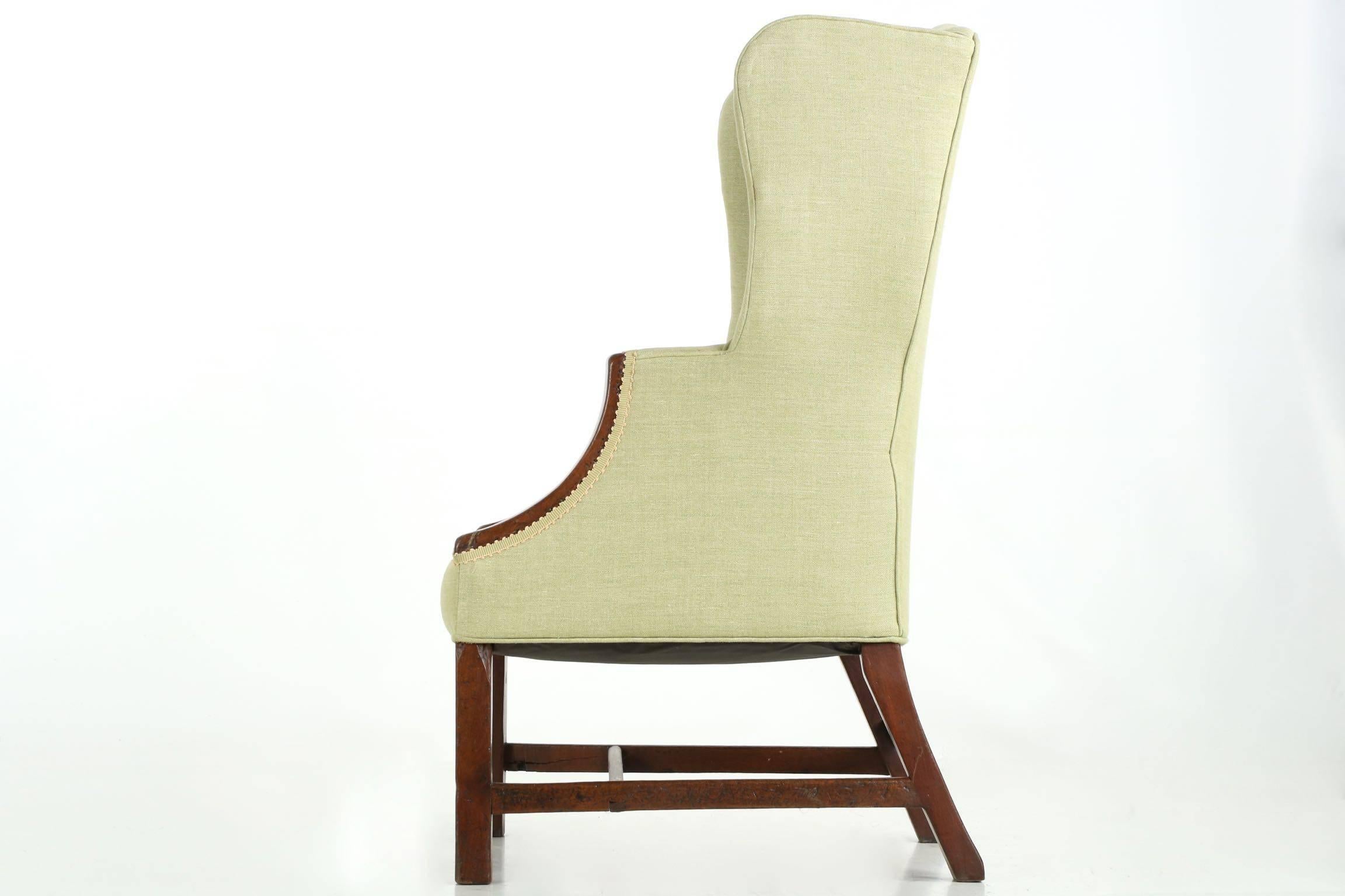 This unusual and most attractive diminutive wingback armchairs crafted with an unrelenting curvature in the wings and crest, these undulating in all three dimensions to hug the sitter most effectively. Designed for a very petite sitter or possibly