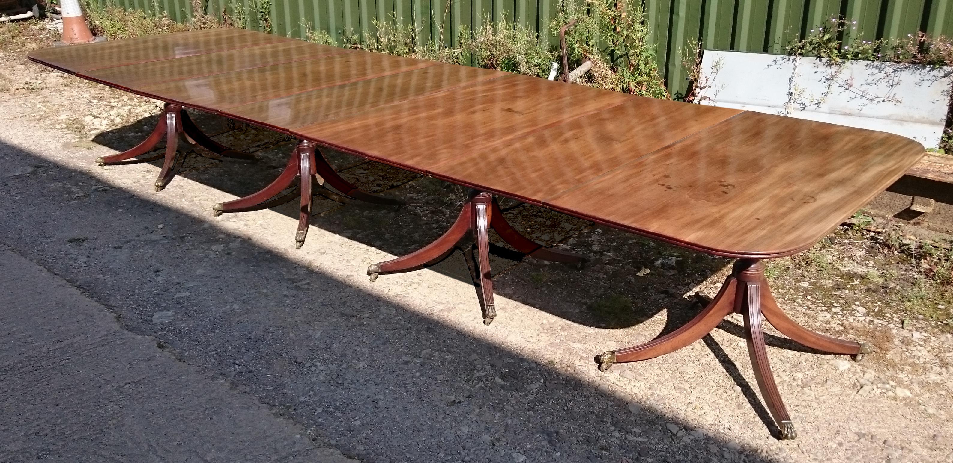 18th century mahogany antique dining table standing on four pedestals, each with four splay base. This is a wonderful table which has faded to a desirable golden brown honey color. The bases are strong and a generous shape and the top of each leg