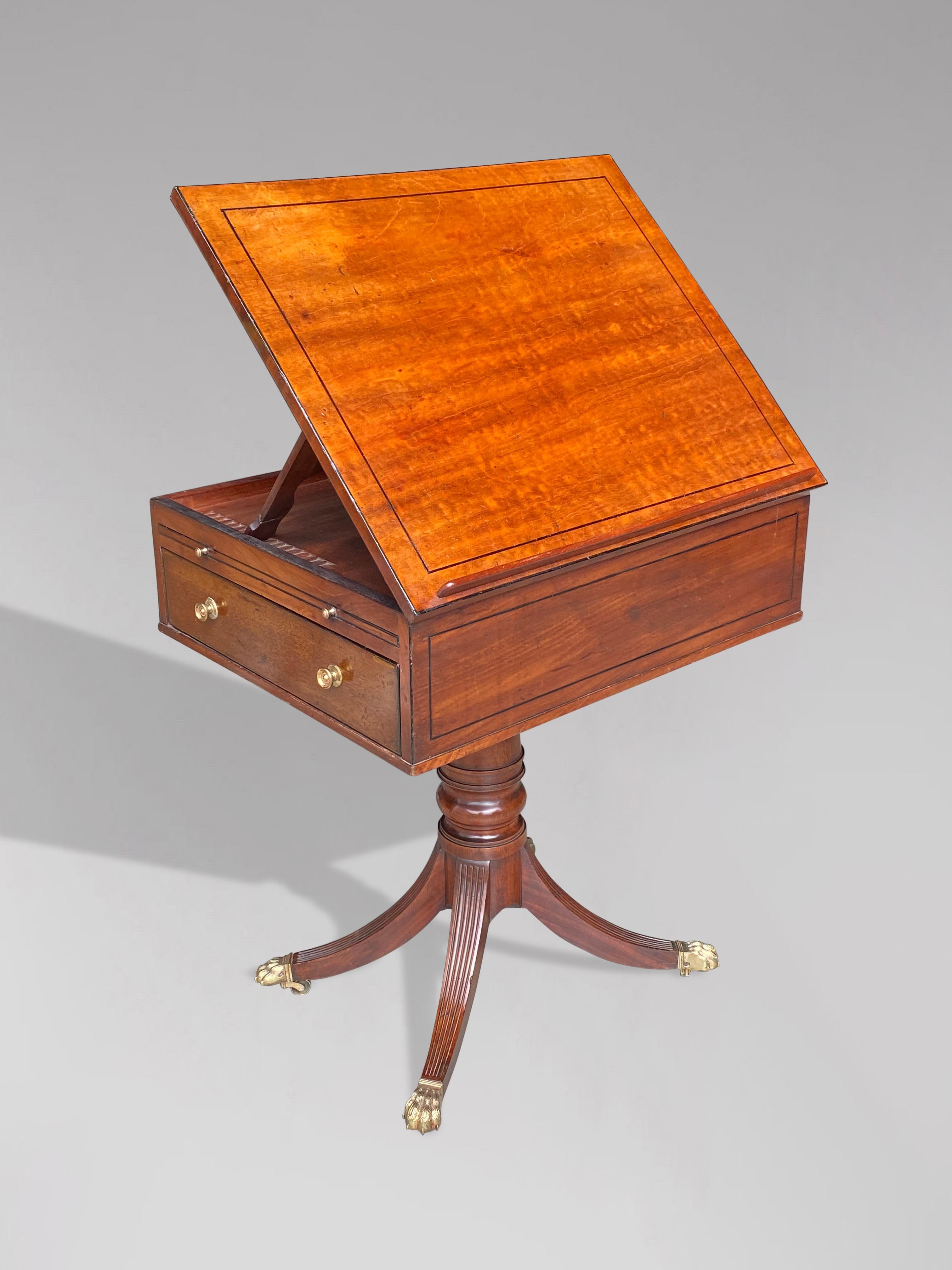 A fine early 19th century George III period mahogany and ebony inlay reading table. The table features one faux drawer to one side and has a rise and fall reading slope. One side of the table having a working mahogany lined drawer and slide with