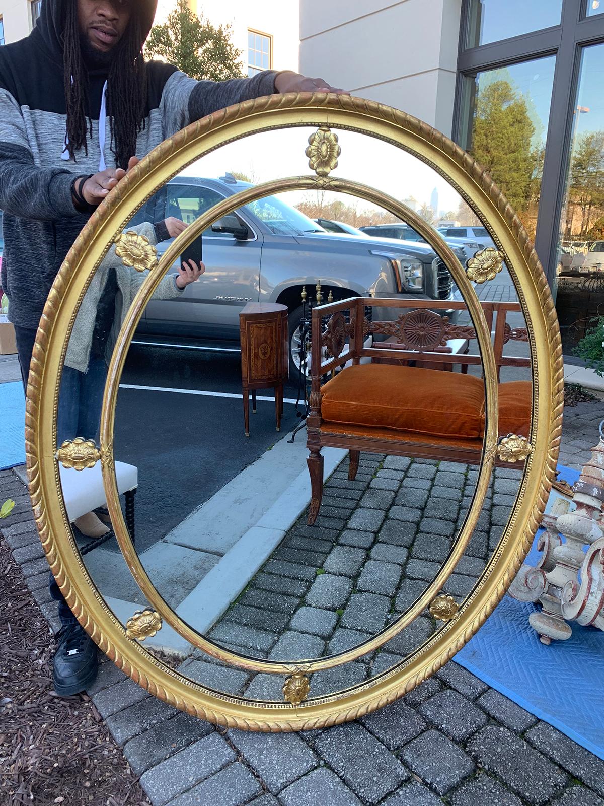 19th century George III style large oval giltwood mirror.