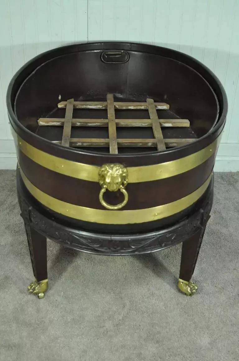 19th Century George III Style Mahogany and Brass Wine Cooler Cellarette on Stand. Item features a brass bound mahogany tub with solid brass lion form handles, removable metal basin insert with wooden slotted interior. The mahogany tub is removable