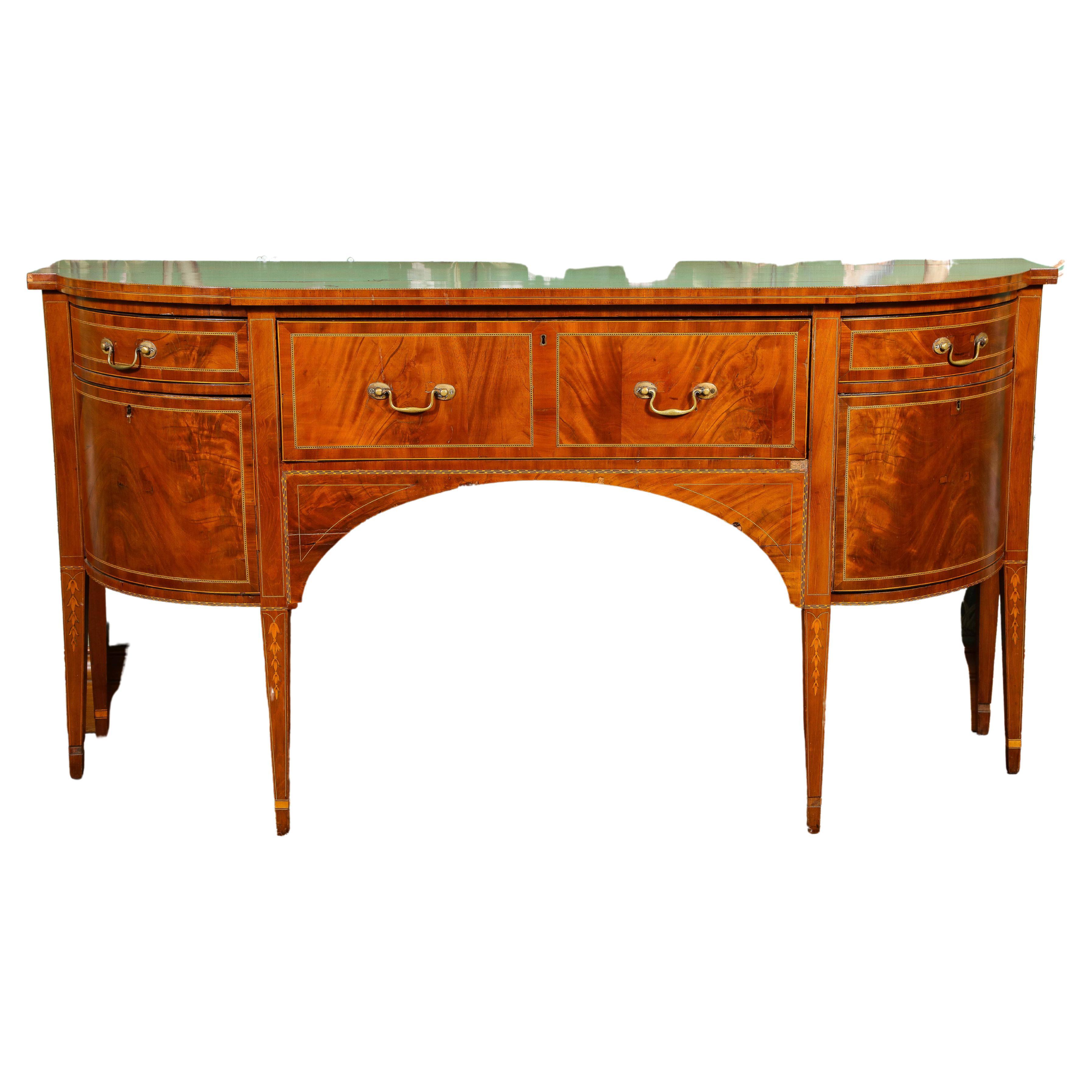 19th Century George III style parquetry inlaid bowfront mahogany buffet or sideboard. Center drawer with two rounded cellarette side cabinets with small drawers above. Stands firmly on six square tapered legs. Key included, functions but is a little