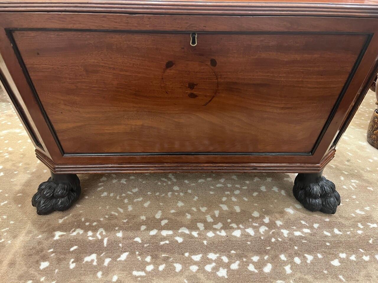The 19th-century George IV mahogany cellarette showcases exquisite craftsmanship and classic George IV design. This piece, typically used for storing wine bottles, features rich mahogany wood and a sophisticated, timeless aesthetic characteristic of