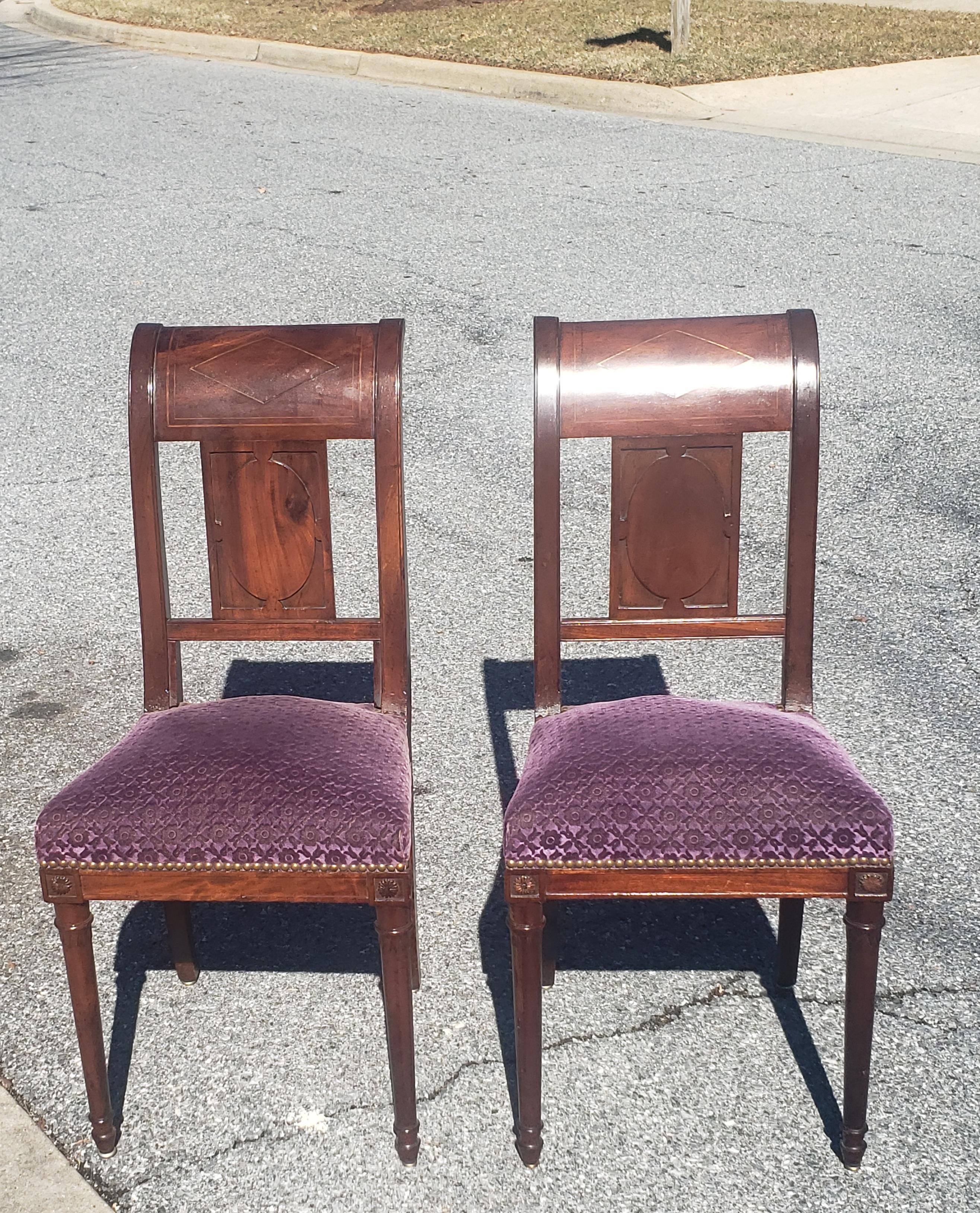 A rare pair of Continental Mahogany and brass inlay upholstered side chairs attributed to the famous French cabinet maker Georges Jacob. Very firm, reupholstered seats with springs. We have a total of 4 in our inventory, two separatedly listed as