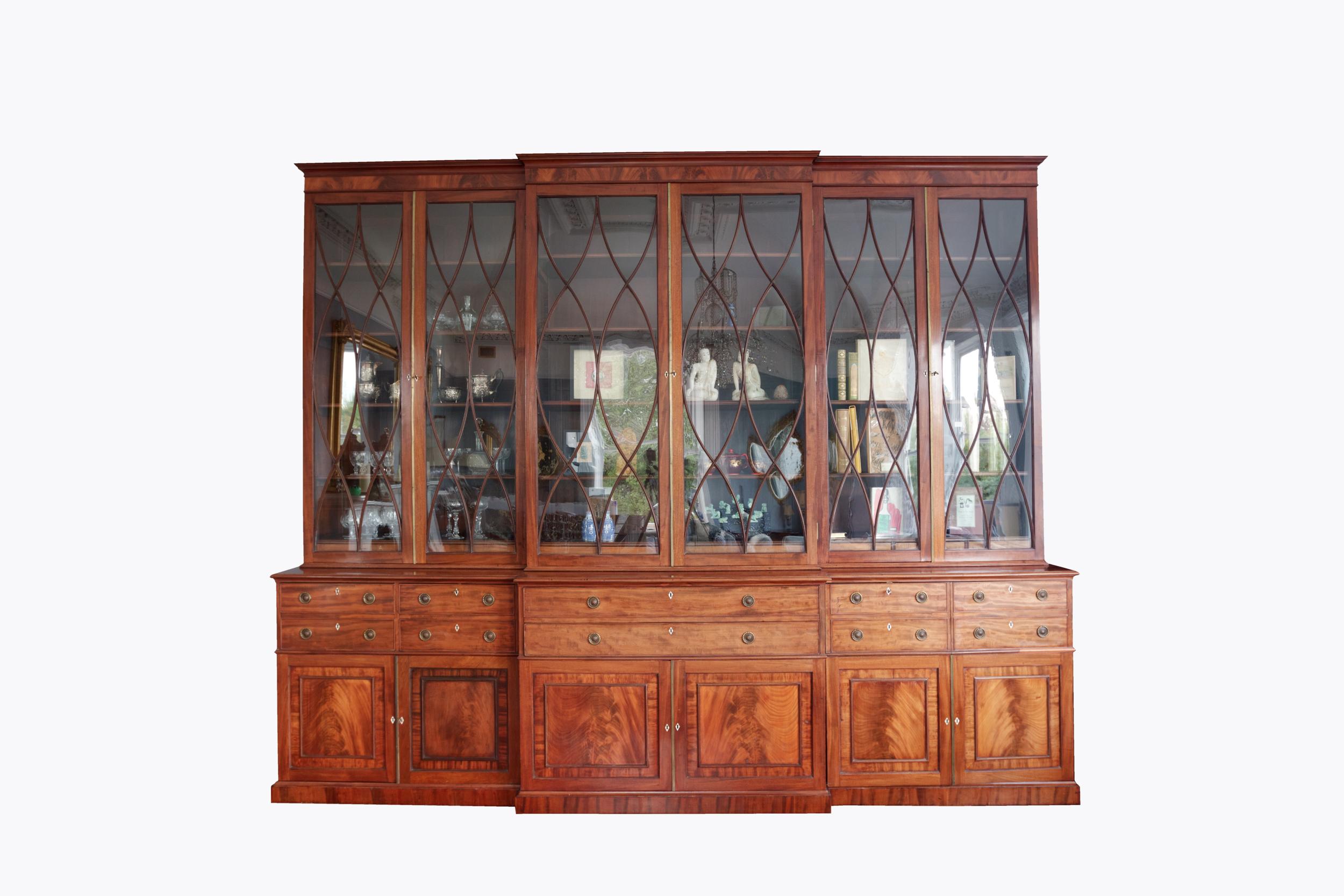 19th Century Georgian six door breakfront secretaire bookcase. The molded cornice to the top sits above six elliptical paned glass doors to the upper section which opens to adjustable interior shelves. The centre section with secretaire drawer opens