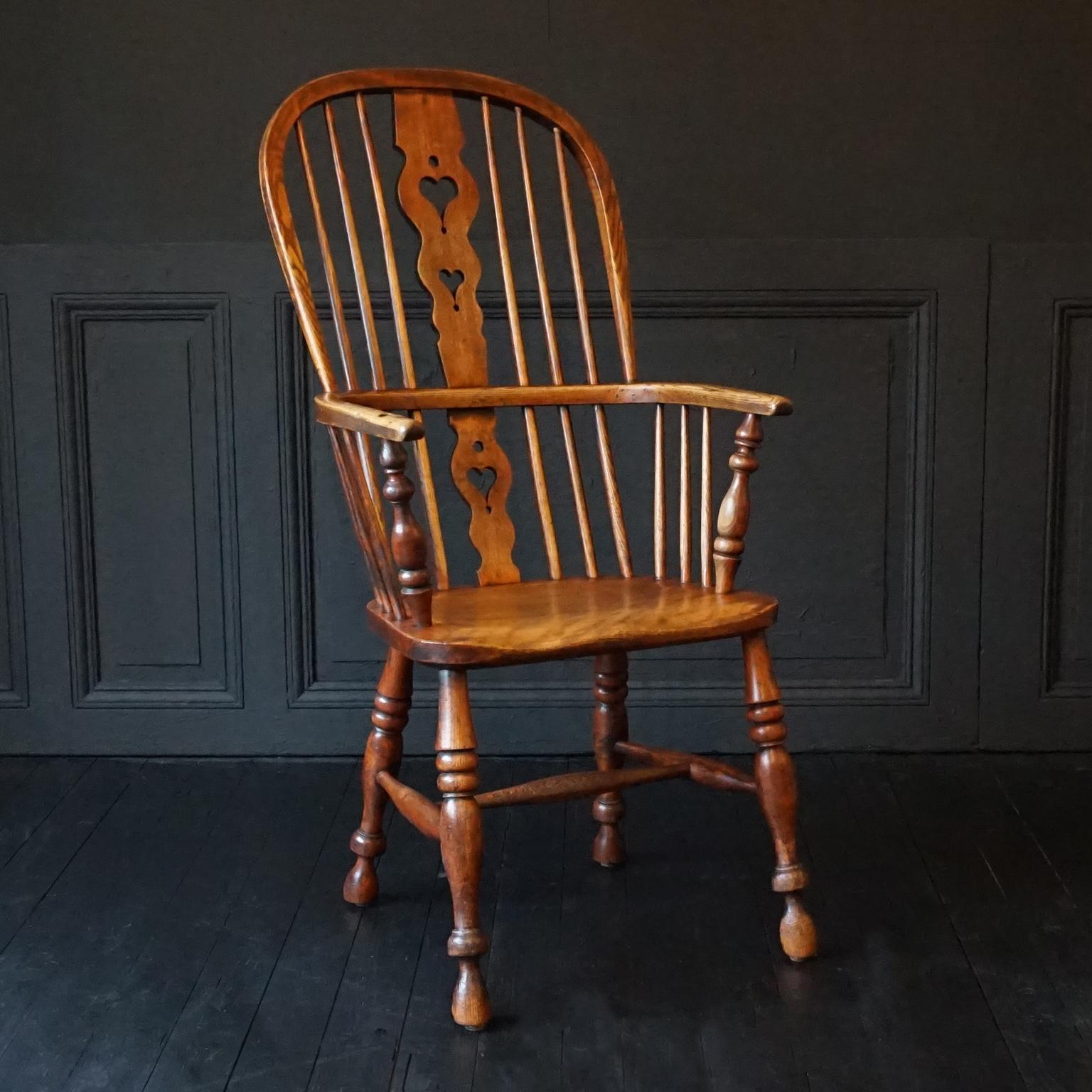 A lovely late Georgian early Victorian yew & elm comb hoop back Windsor chair.
The central back splat is pierced with hearts, hoop stretcher arm rests, shaped narrow seat (see measurements), raised on splayed baluster turned legs 

seat