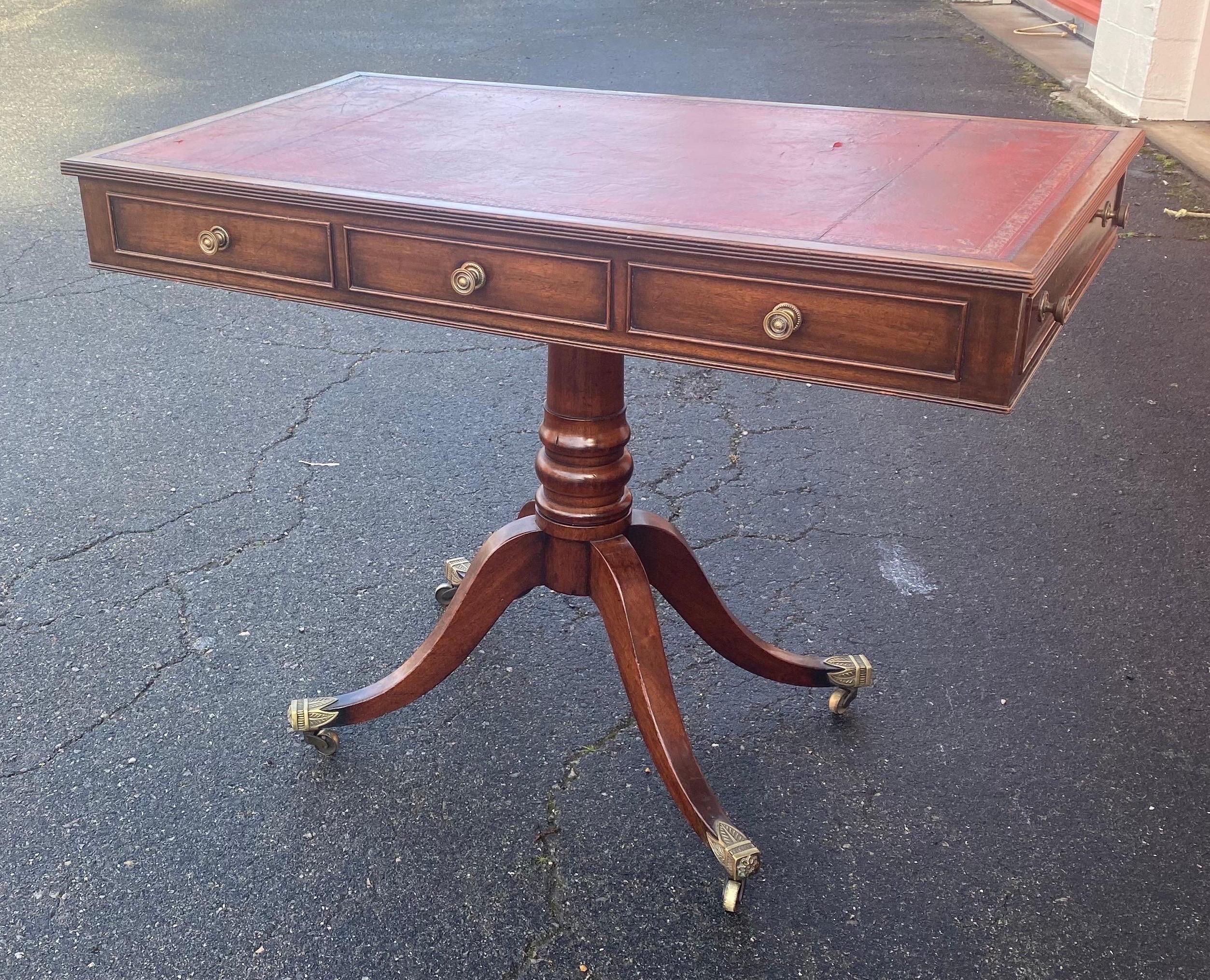 Unique form 19th century Georgian leather top table with side drawers. Great quality mahogany, leather top and castors.