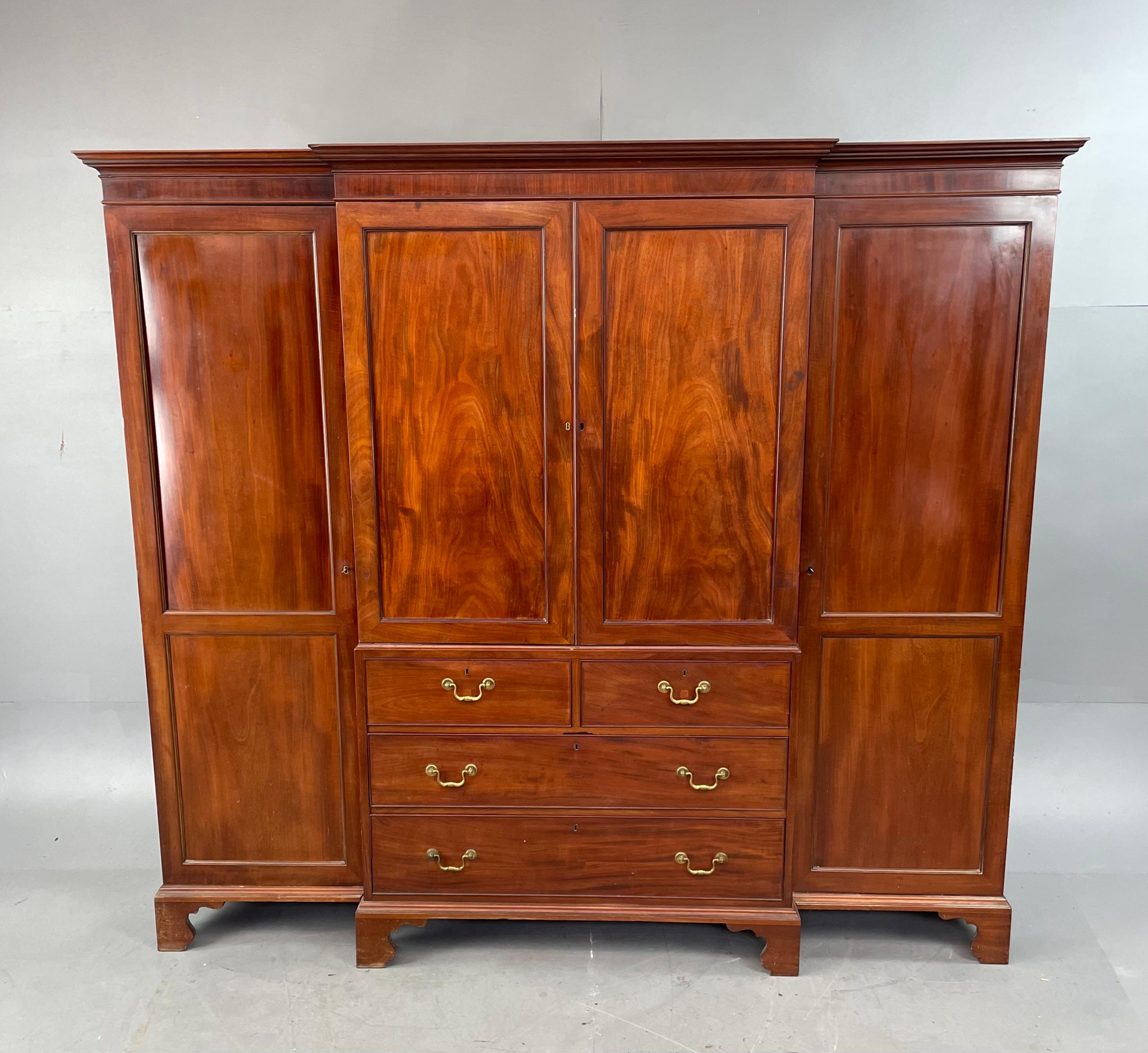 Fine quality 19th century mahogany breakfront four door wardrobe .
The wardrobe has two lined hanging sections with a fitted double section , the centre top section retains it original slide out trays ,these can easily be removed to create more